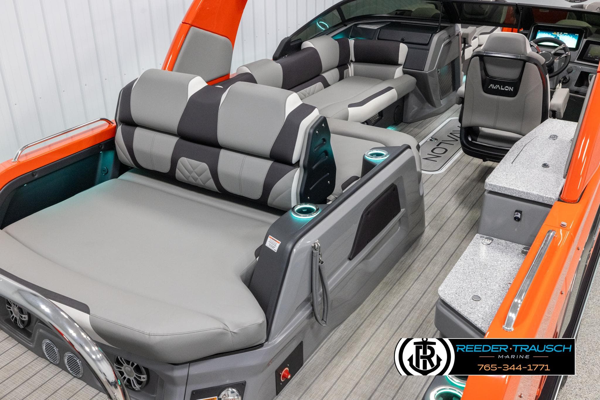 2024 Avalon Excalibur VRB boat interior with gray and orange seating, modern design.