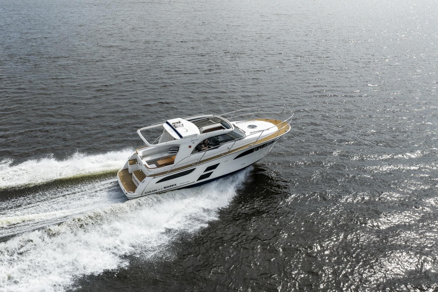 2020 Marex 310 Sun Cruiser speeding on open water, showcasing sleek design and performance.