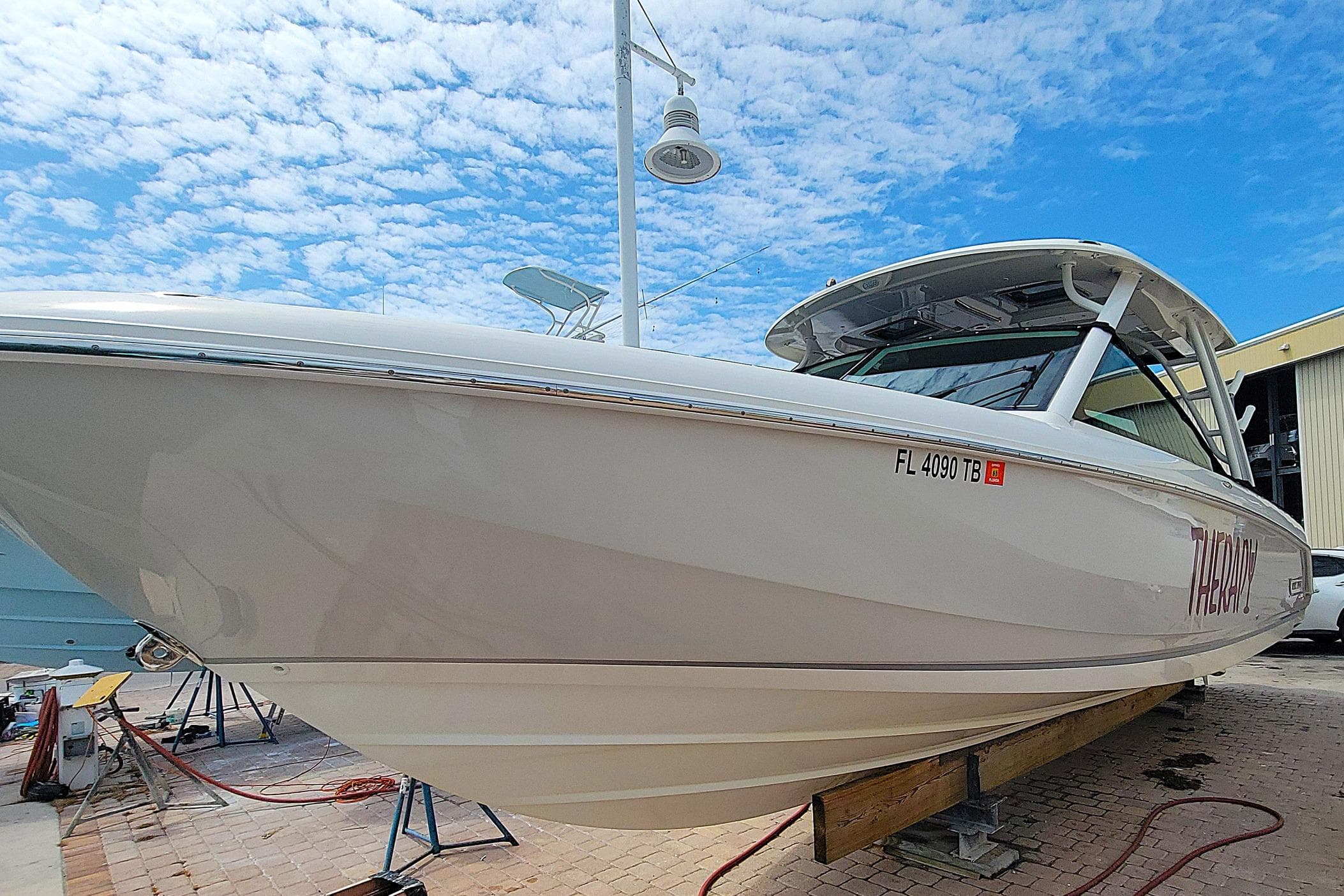 2022 Boston Whaler 320 Vantage boat on display under a clear blue sky.