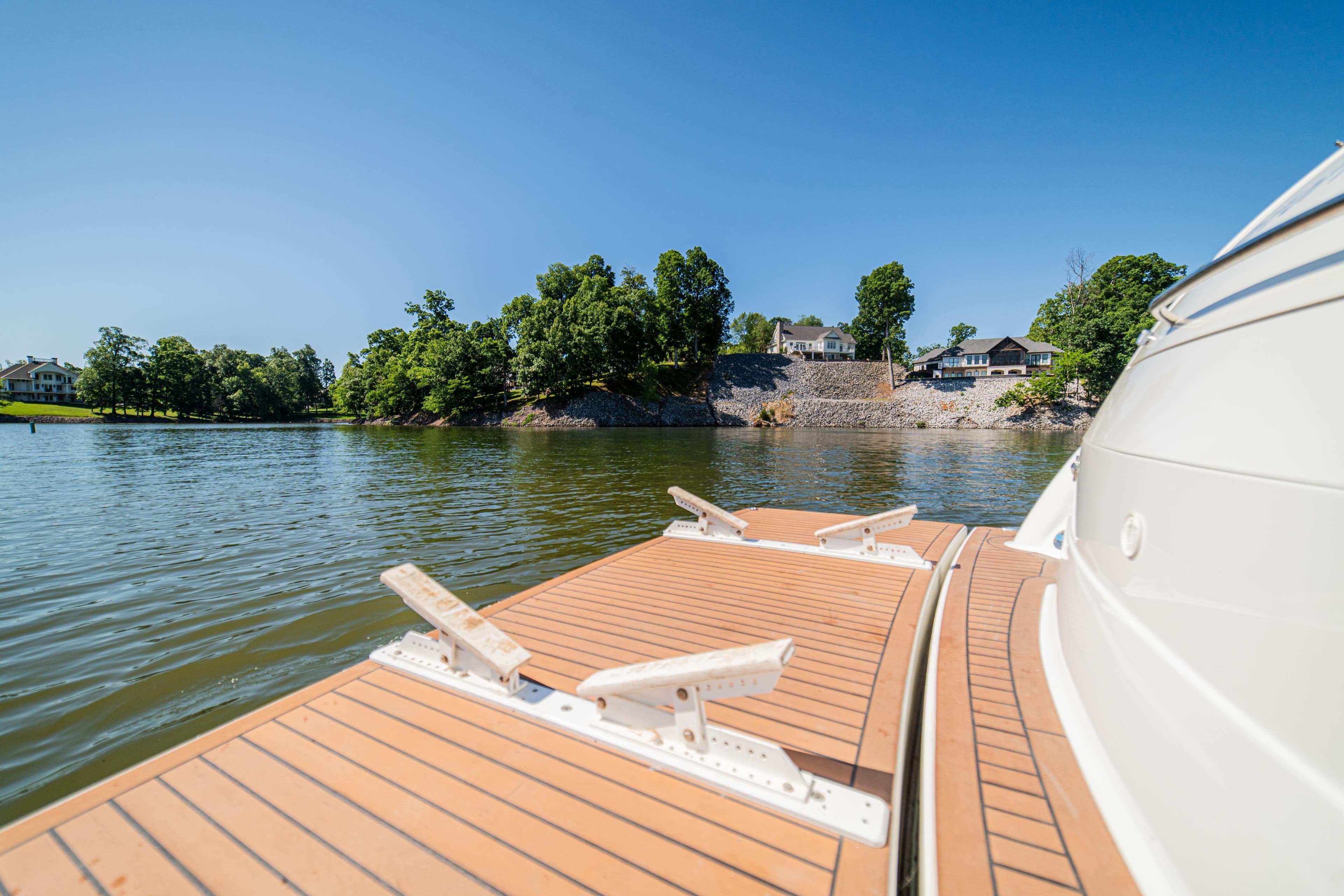2008 Formula 45 Yacht on serene lake with scenic shoreline view.