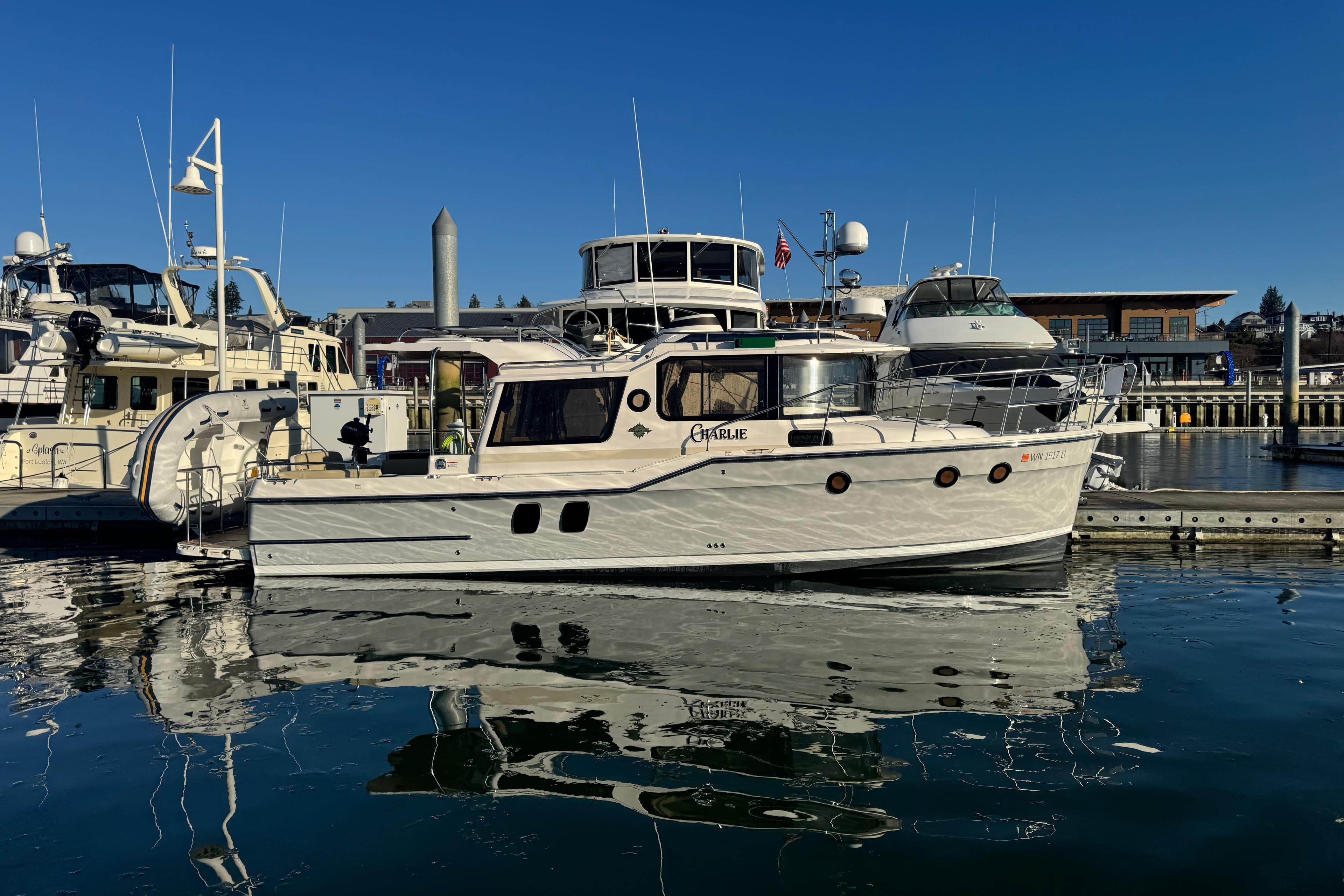 2024 Ranger Tugs R-29 S docked at a marina under clear blue skies.