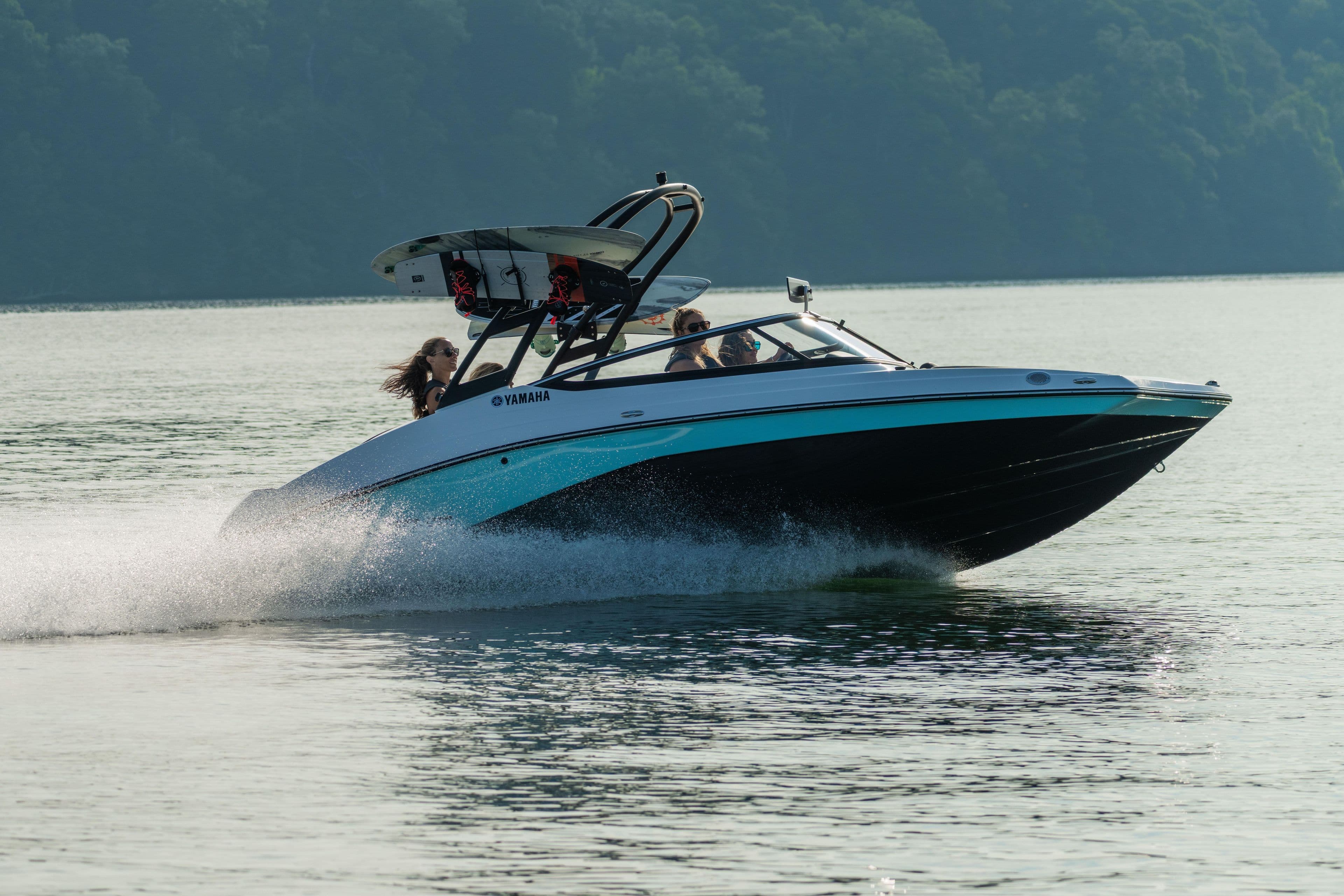 Manufacturer Provided Image: 2026 Yamaha AR195 boat speeding on a calm lake with passengers enjoying the ride.