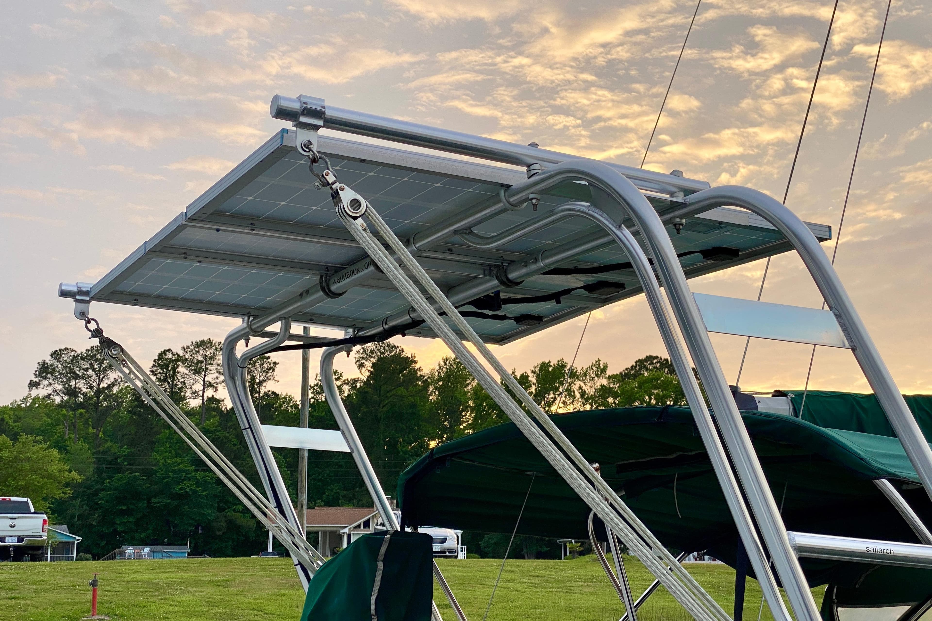 Solar panel installation on 1992 Island Packet 29 sailboat at sunset.