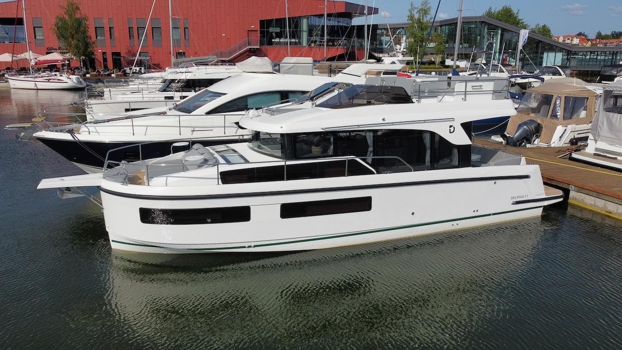2023 Delphia 11 Flylounge yacht docked at a marina.