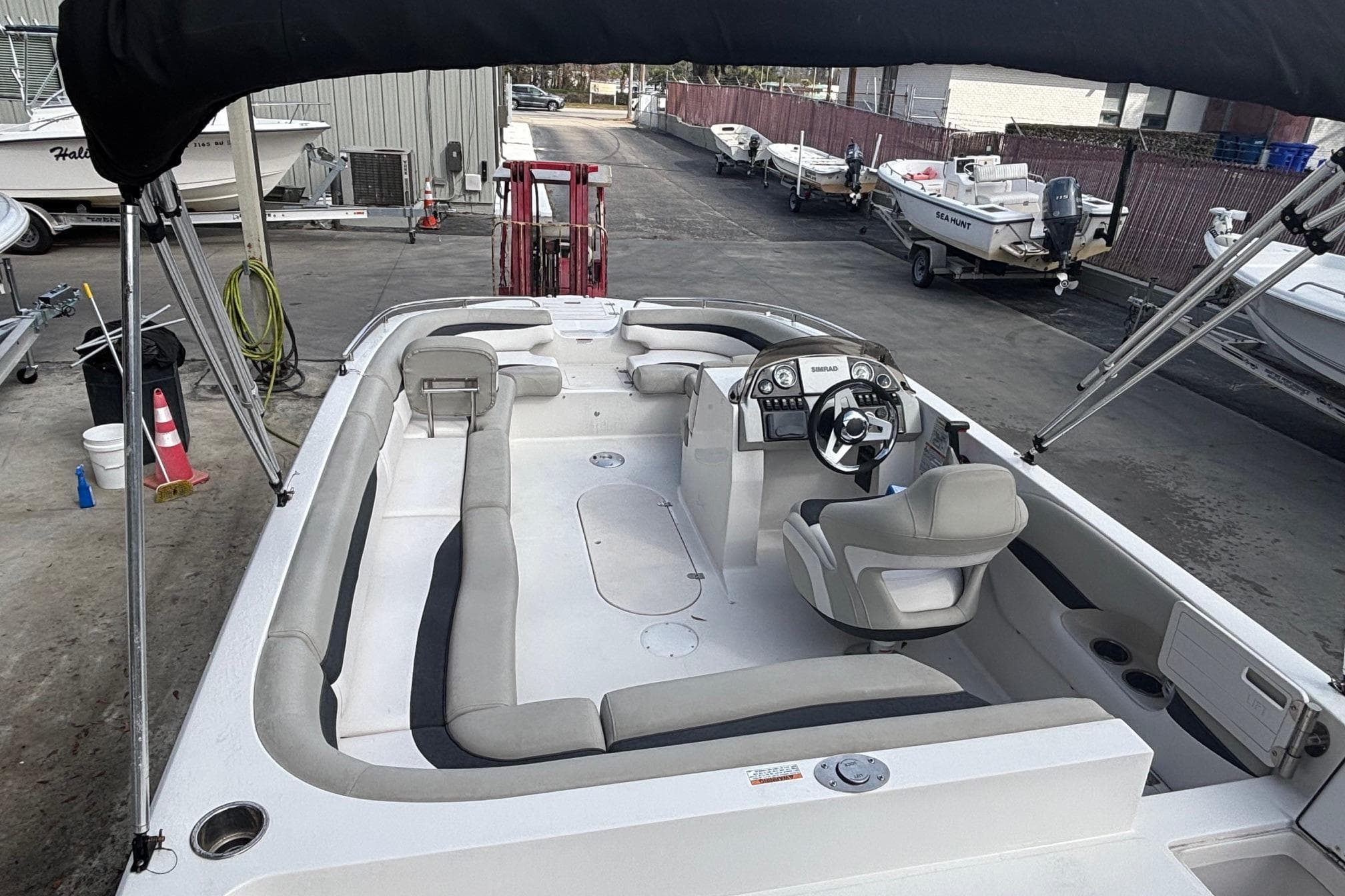 2019 Starcraft MDX 191 O/B boat with spacious seating and modern helm, docked outdoors.
