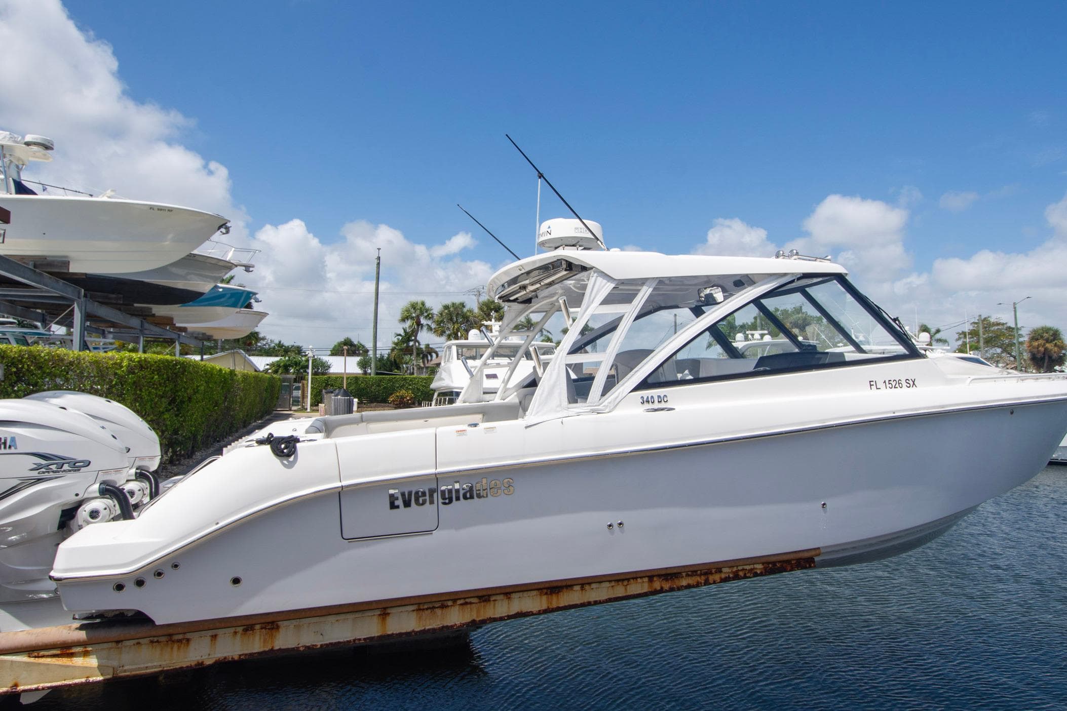 2019 Everglades 340 Dual Console boat docked under clear blue sky.