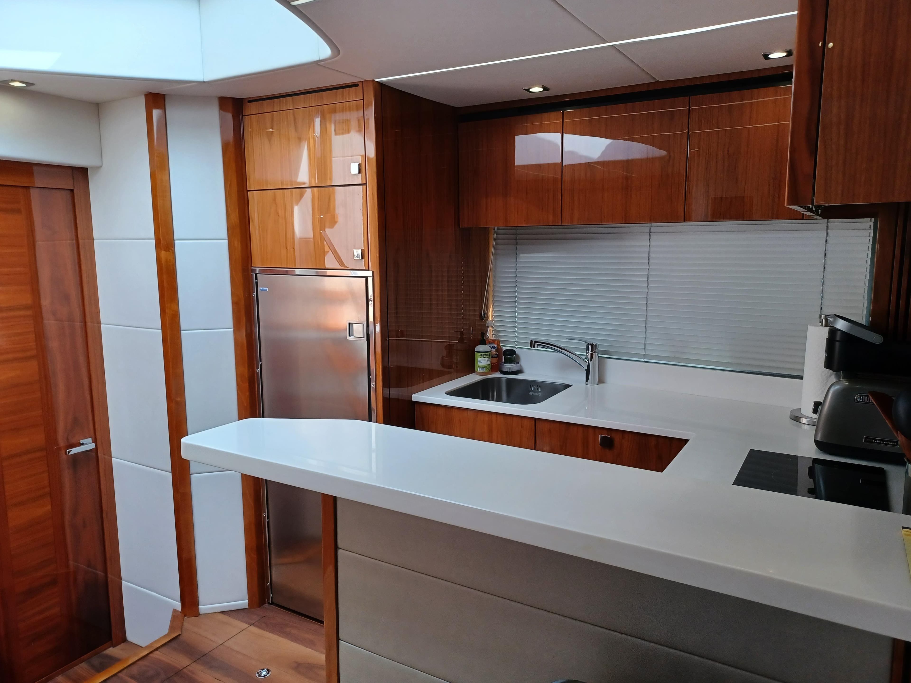 Luxurious kitchen interior of 2020 Sunseeker Predator 50 yacht with modern amenities.