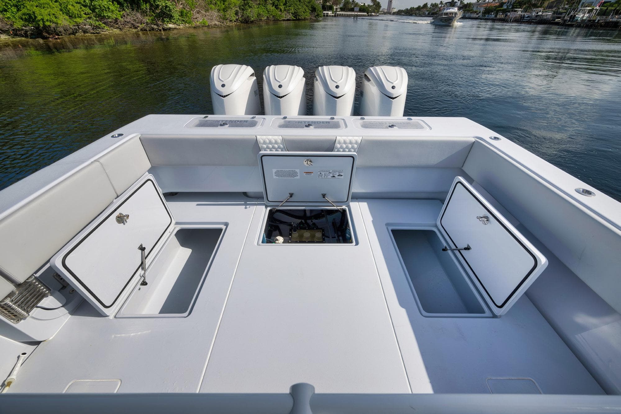 2025 Contender 44 ST boat deck with open storage compartments and quad engines.