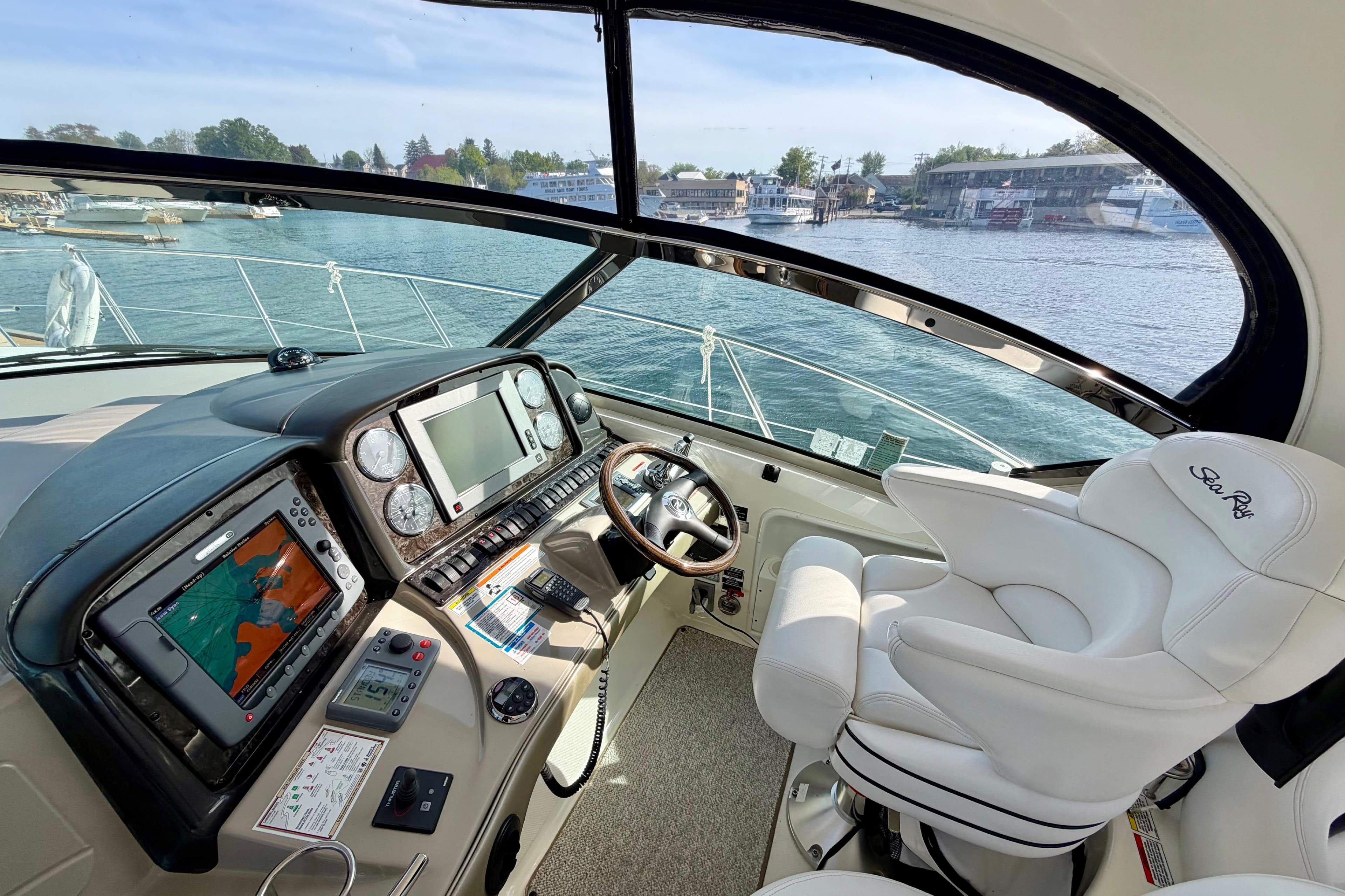 Helm of 2008 Sea Ray 44 Sundancer yacht with navigation equipment and luxurious seating.