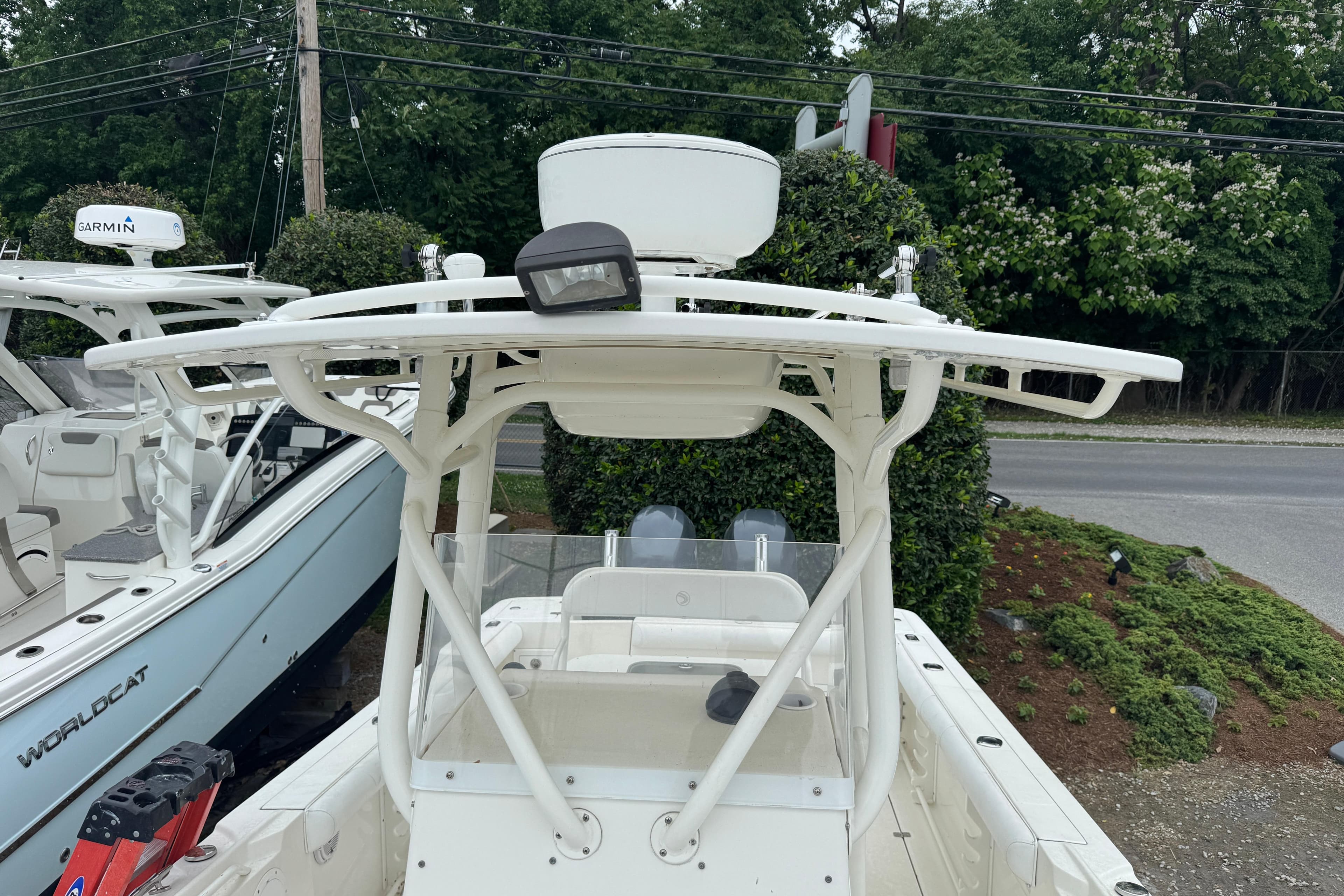 2007 Edgewater 245CC boat with T-top and Garmin radar, parked outdoors.