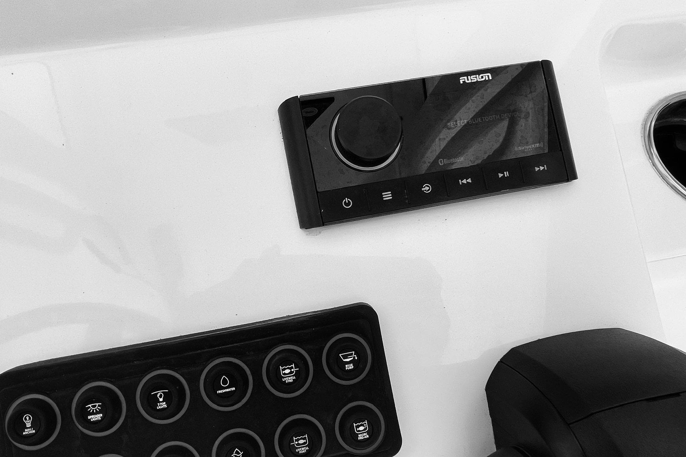 Control panel of 2024 Sportsman Masters 247 Bay Boat with audio system and switches.