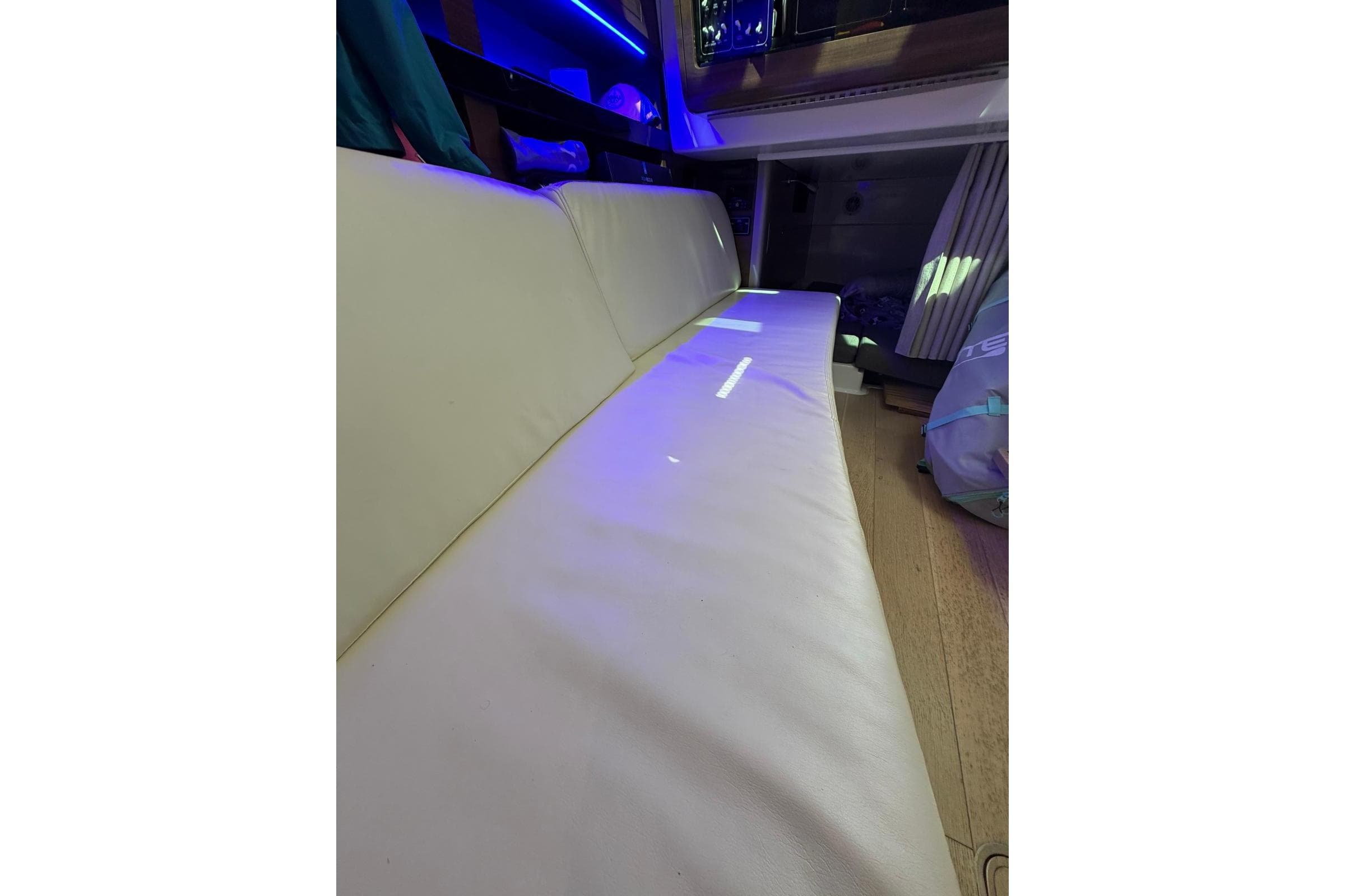 Interior of 2023 Boston Whaler 345 Conquest with white seating and ambient lighting.