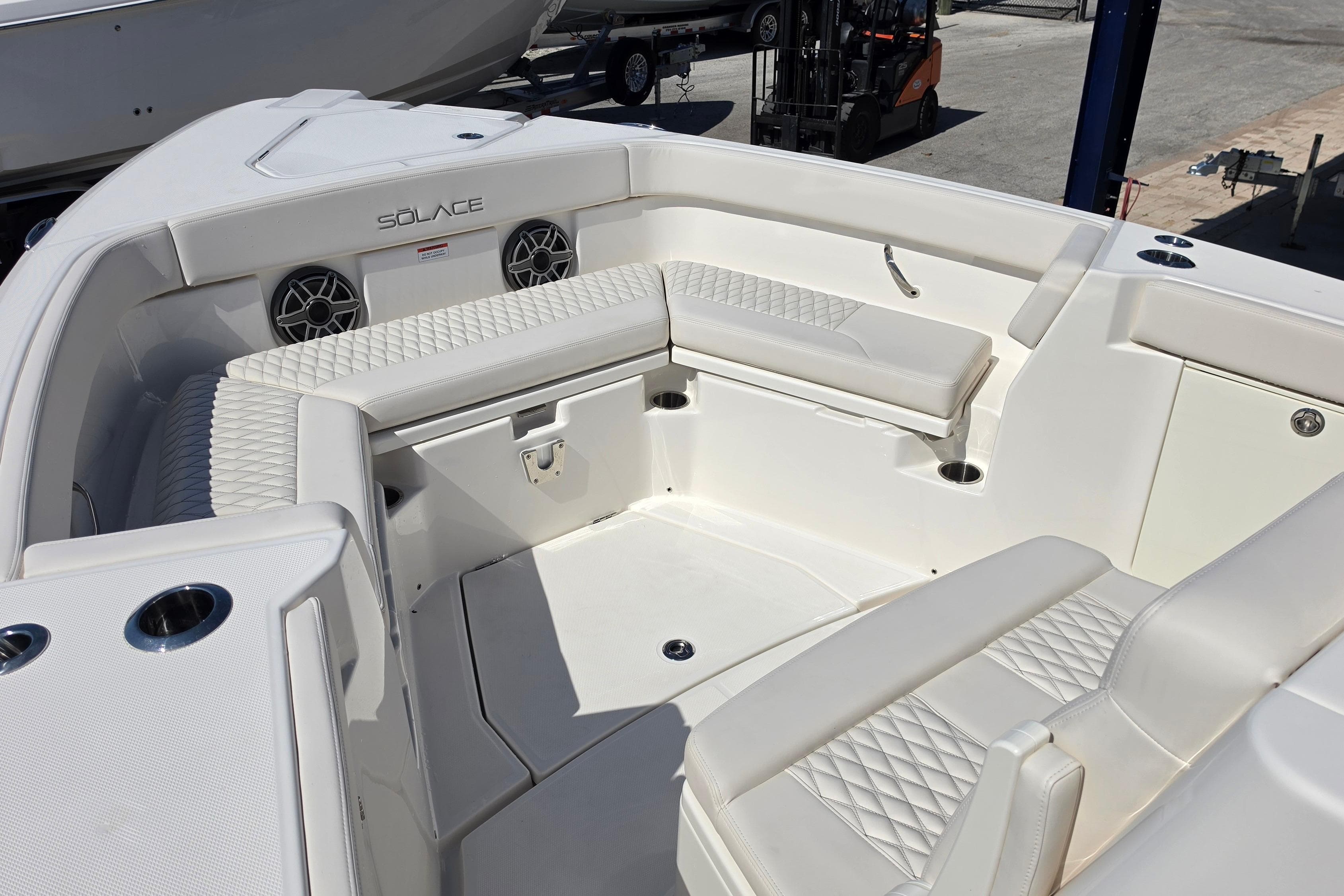 2026 Solace 30CS boat interior with white seating and cup holders.