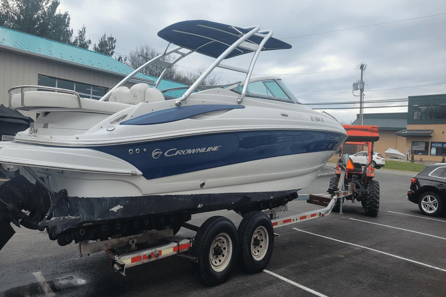 2012 Crownline 265 SS boat on a trailer in a parking lot.
