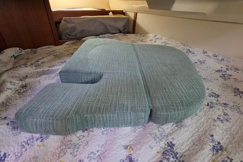 Cushion on floral bedspread inside 1996 Hunter 336 boat cabin.