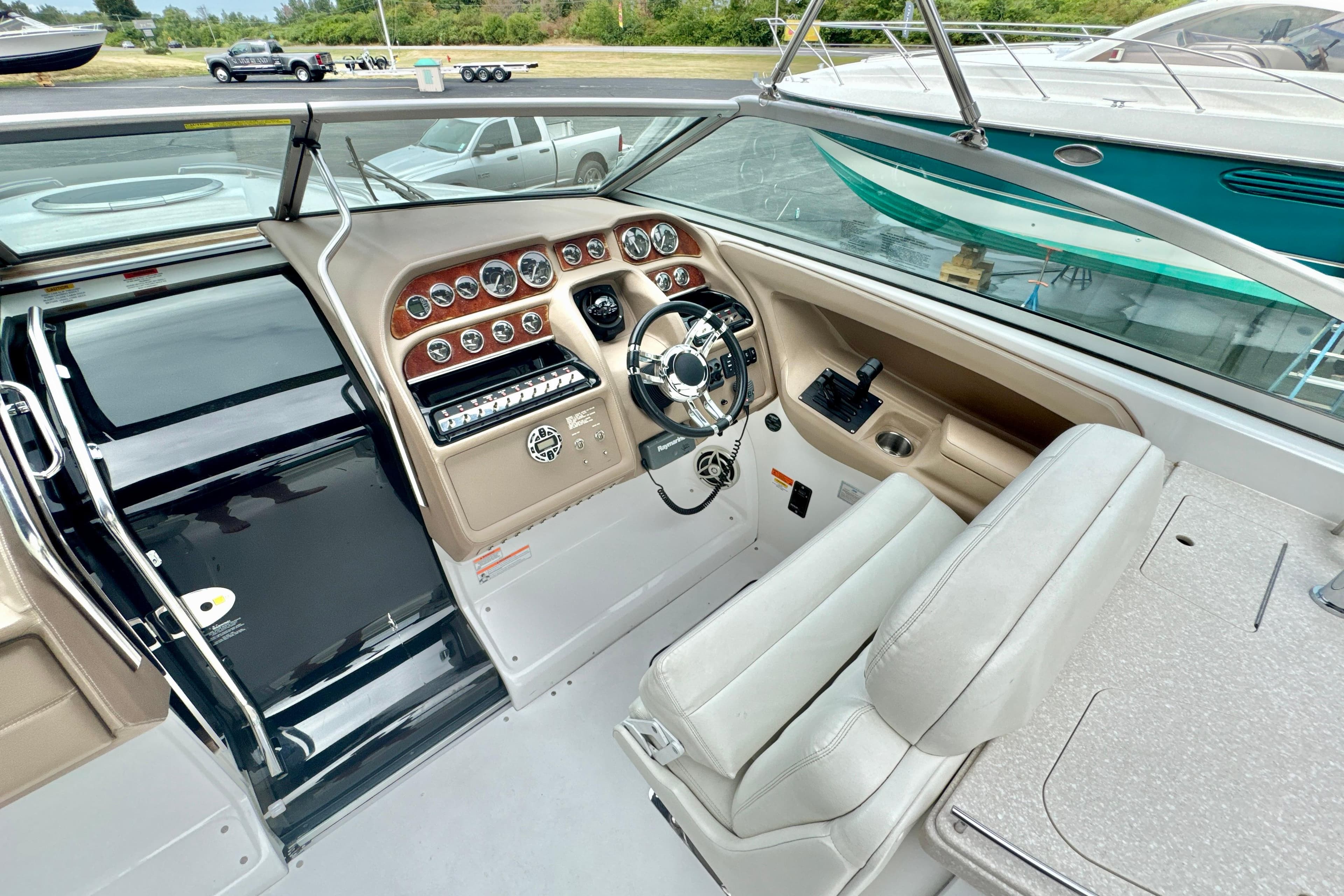 2008 Cobalt 323 boat cockpit with steering wheel, control panel, and comfortable seating.