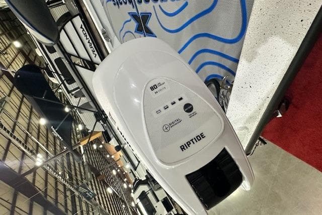 2026 Xpress H20B Bay boat with Riptide motor on display at an indoor exhibition.
