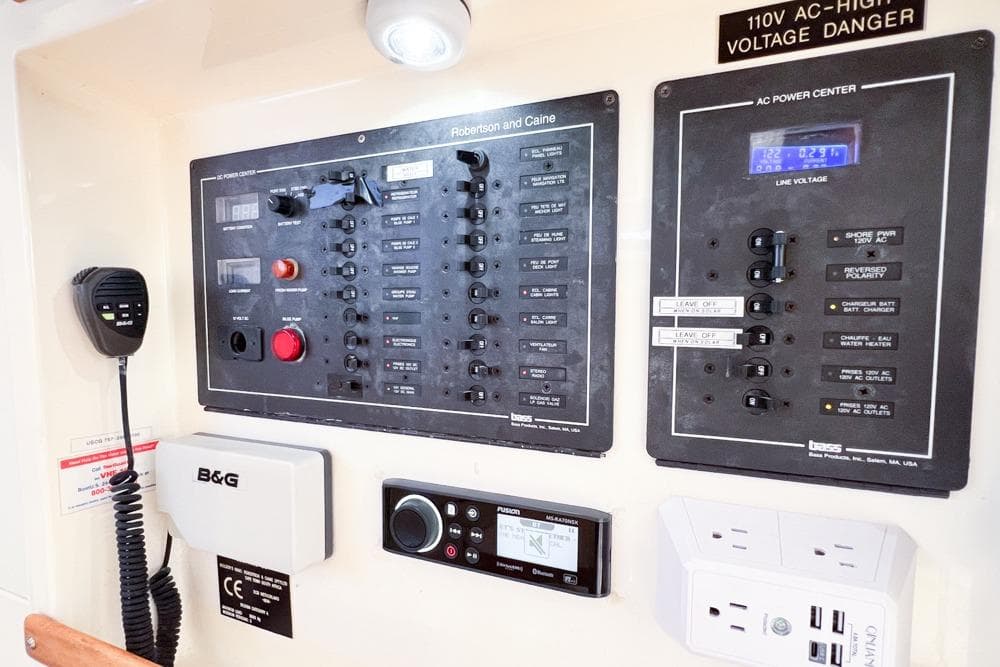 Electrical control panel on a 2000 Leopard 38 catamaran, featuring AC and DC power systems.