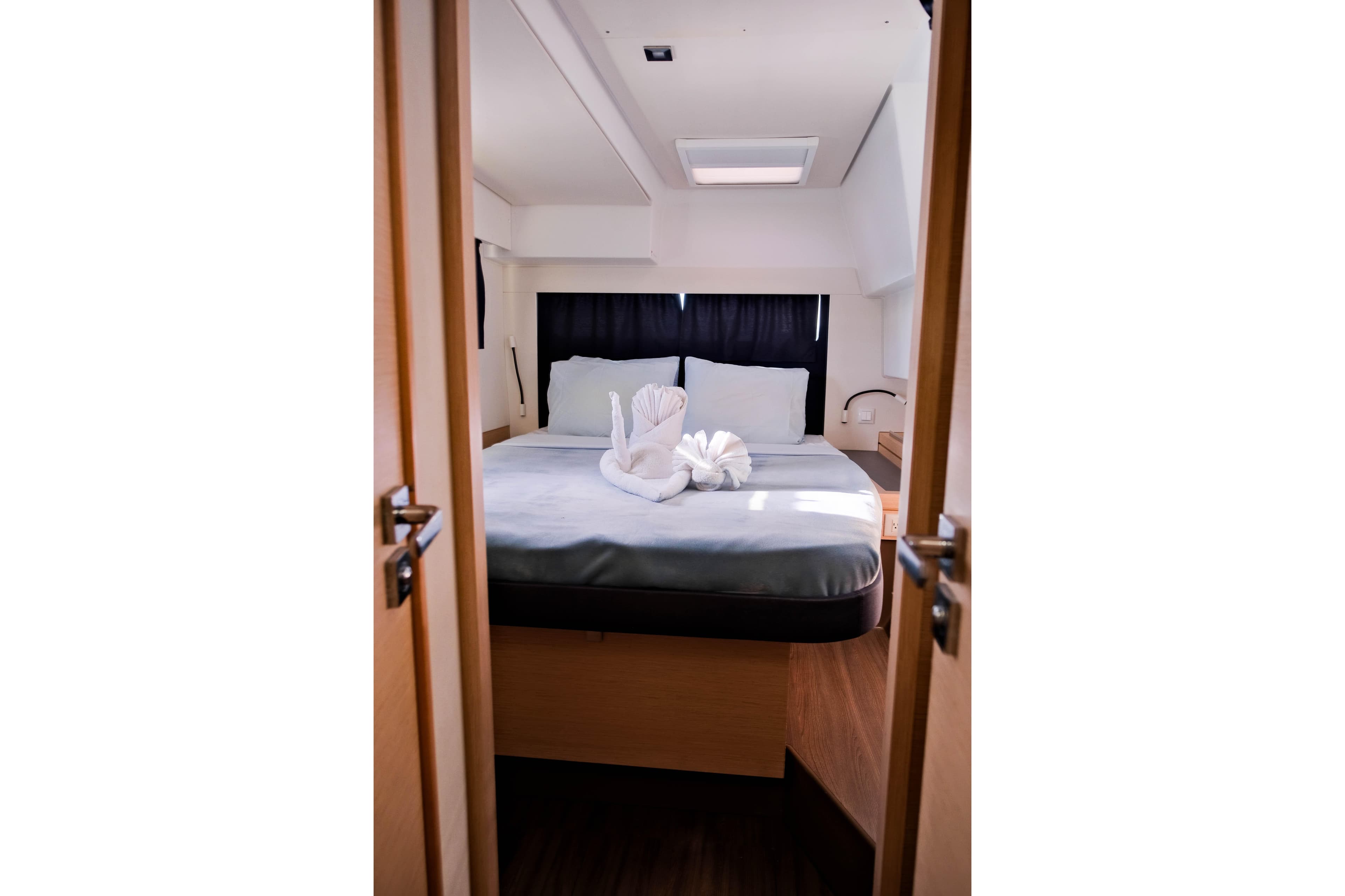 Luxurious cabin interior of 2019 Fountaine Pajot Saona 47 catamaran with elegant bedding.