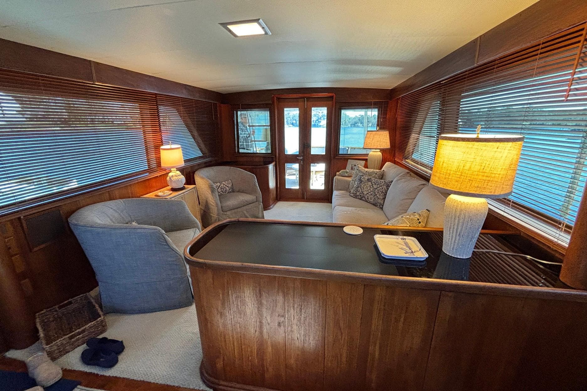 Interior of a 1979 Hatteras 53 Motor Yacht with cozy seating and warm lighting.