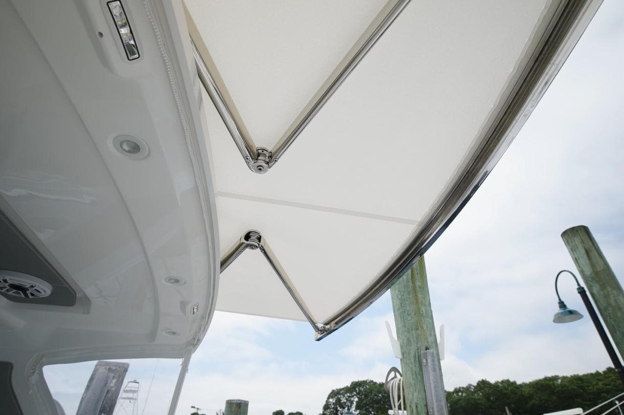 2026 Everglades 367 CX boat canopy detail with dock background.