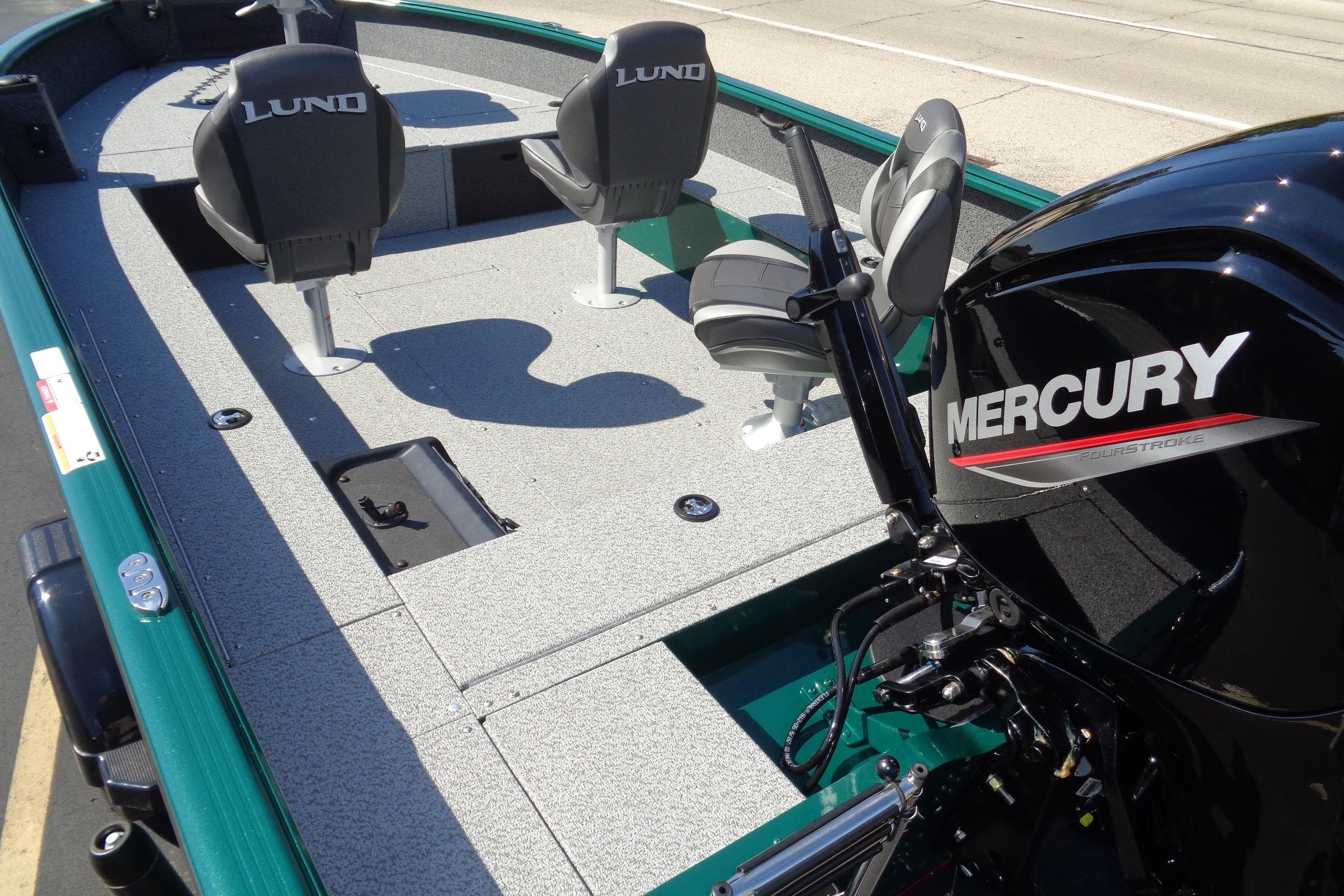 2026 Lund 1800 Explorer Tiller boat with Mercury engine, featuring spacious seating and deck.