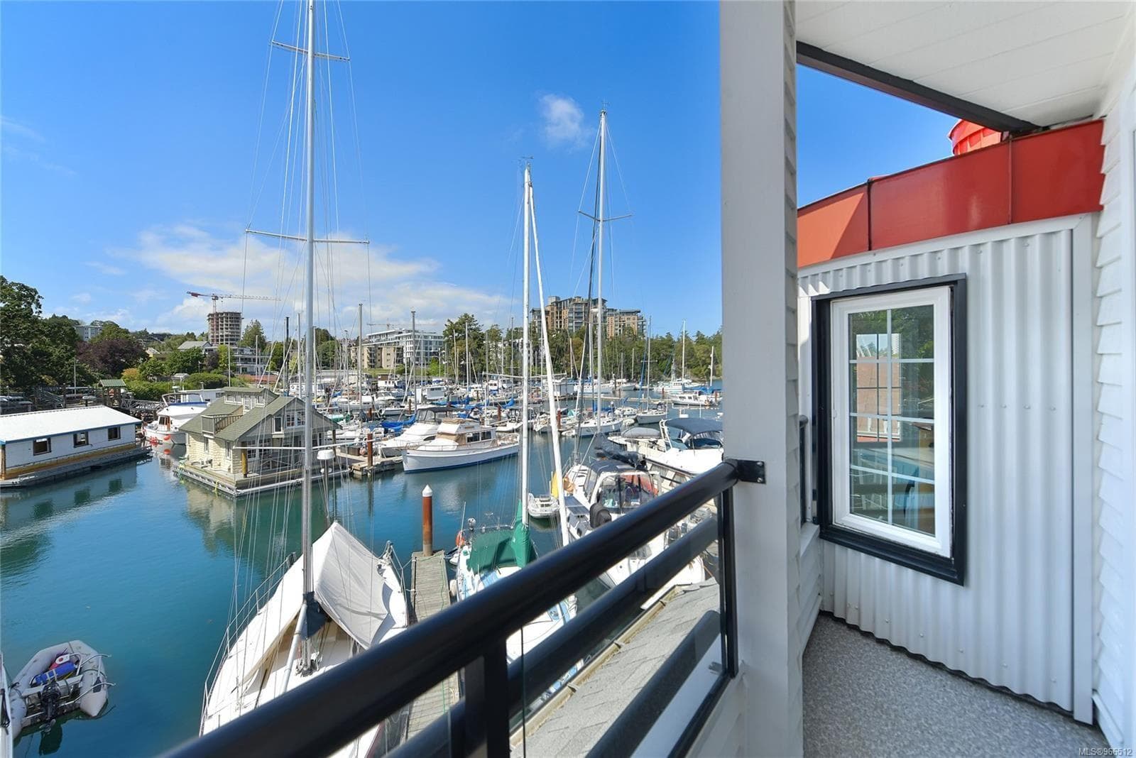 Balcony view of marina with sailboats and waterfront buildings, Custom Float Home, 2005.