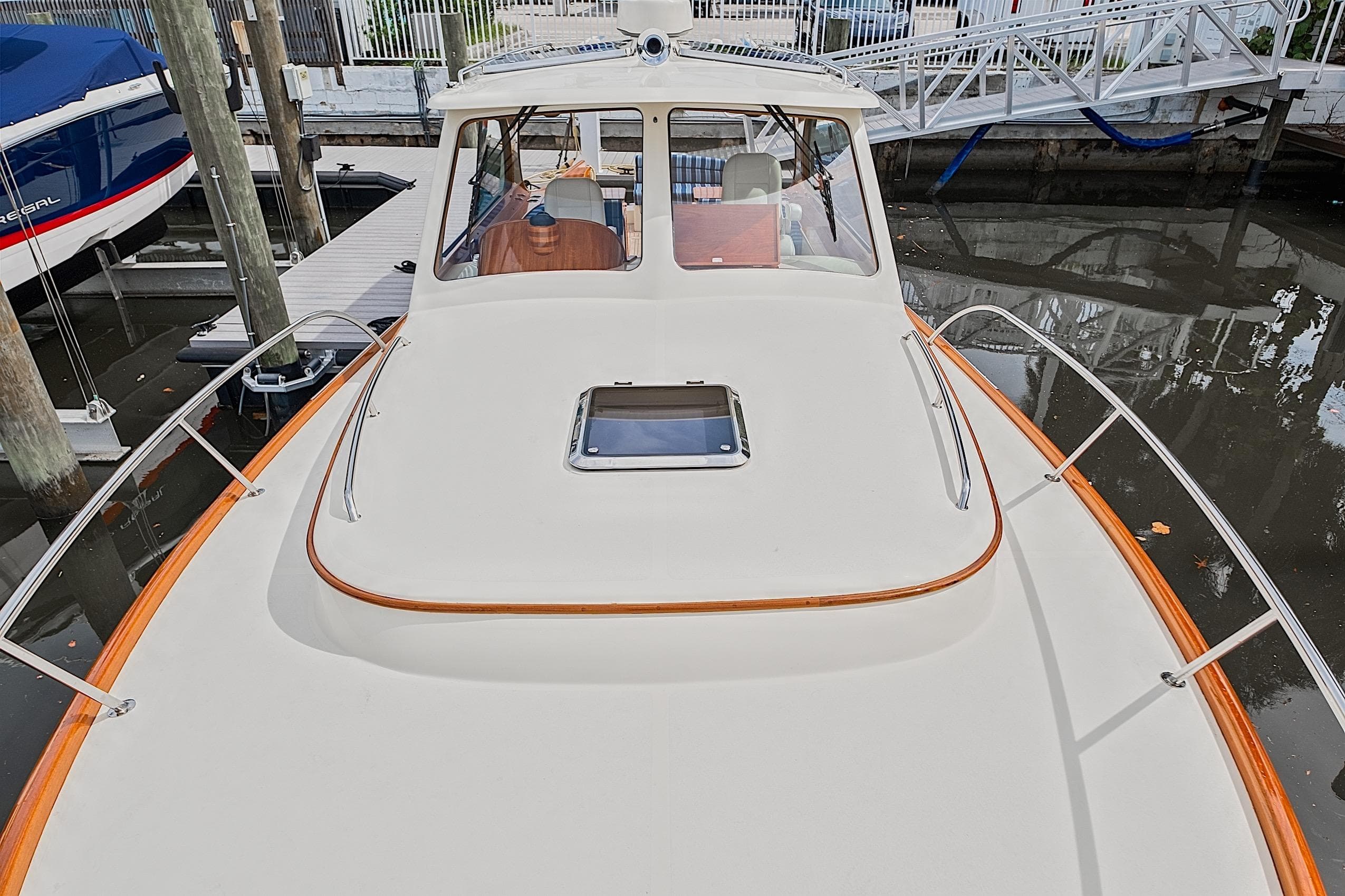2018 Hinckley Picnic Boat 37 MKIII docked, showcasing sleek design and elegant wood accents.