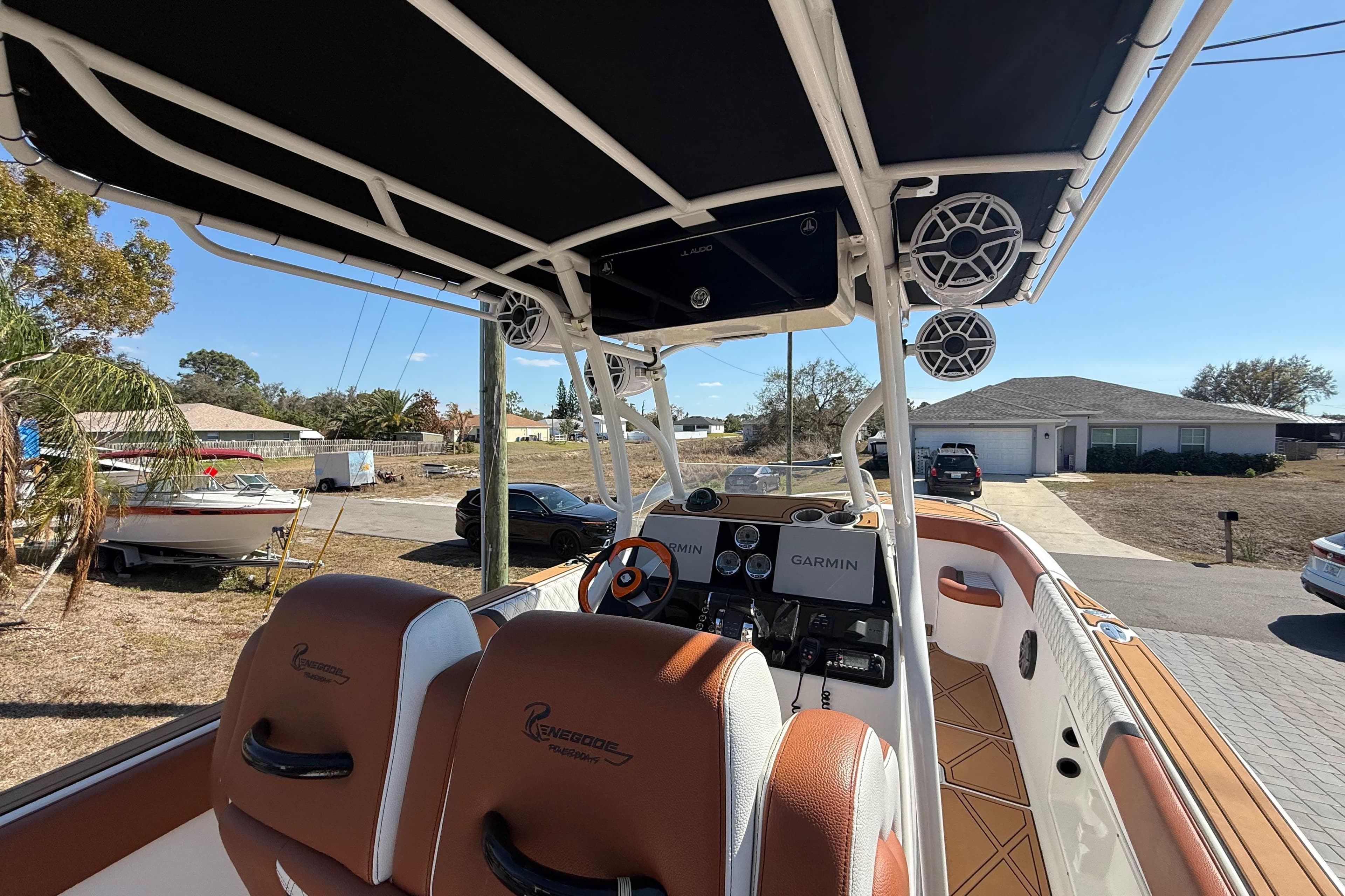 2005 Renegade 29CC boat interior with Garmin navigation, parked in a residential area.