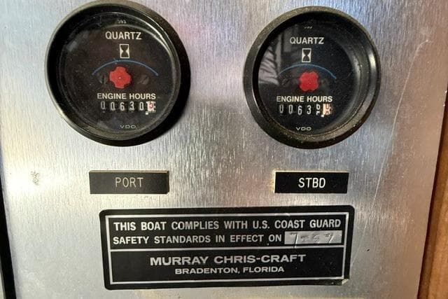 1988 Chris-Craft 381 Catalina engine hour meters and compliance label.