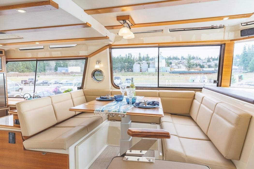Luxurious interior of 2025 Ranger Tugs 43 Command Bridge with spacious seating and dining area.
