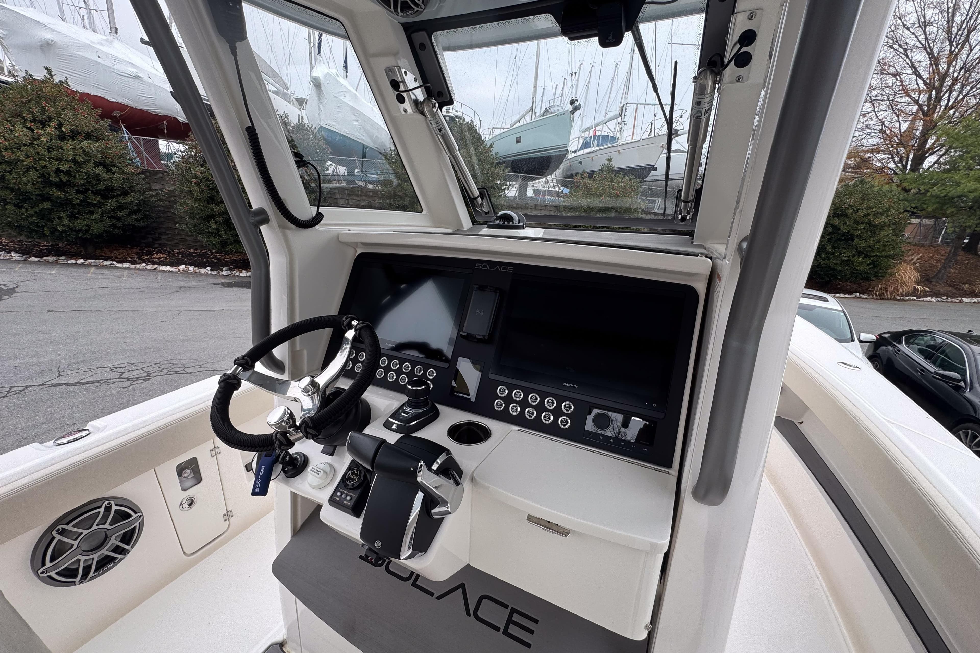 Cockpit of 2025 Solace 30 HCS boat with modern steering and control panel.