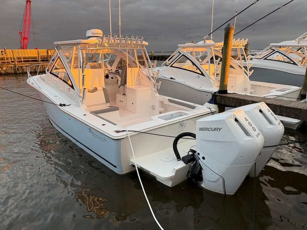 2025 Albemarle 30 Express boat docked with twin Mercury engines.