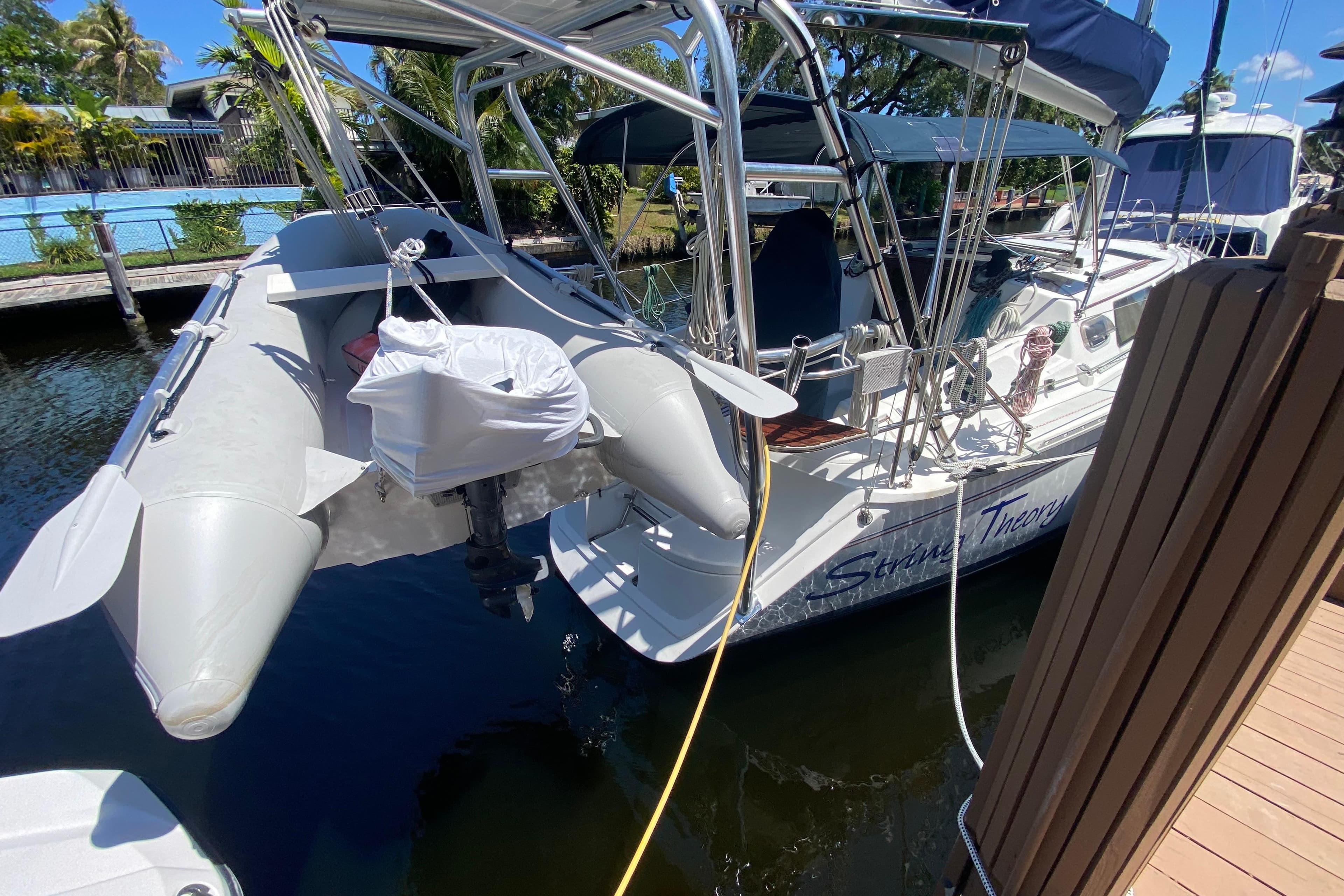 Hunter 33.5 sailboat from 1995 docked with inflatable dinghy attached.