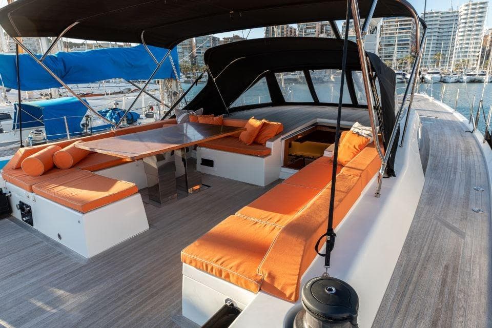 Luxurious 2022 Solaris 64RS yacht with orange seating and sleek design in marina.