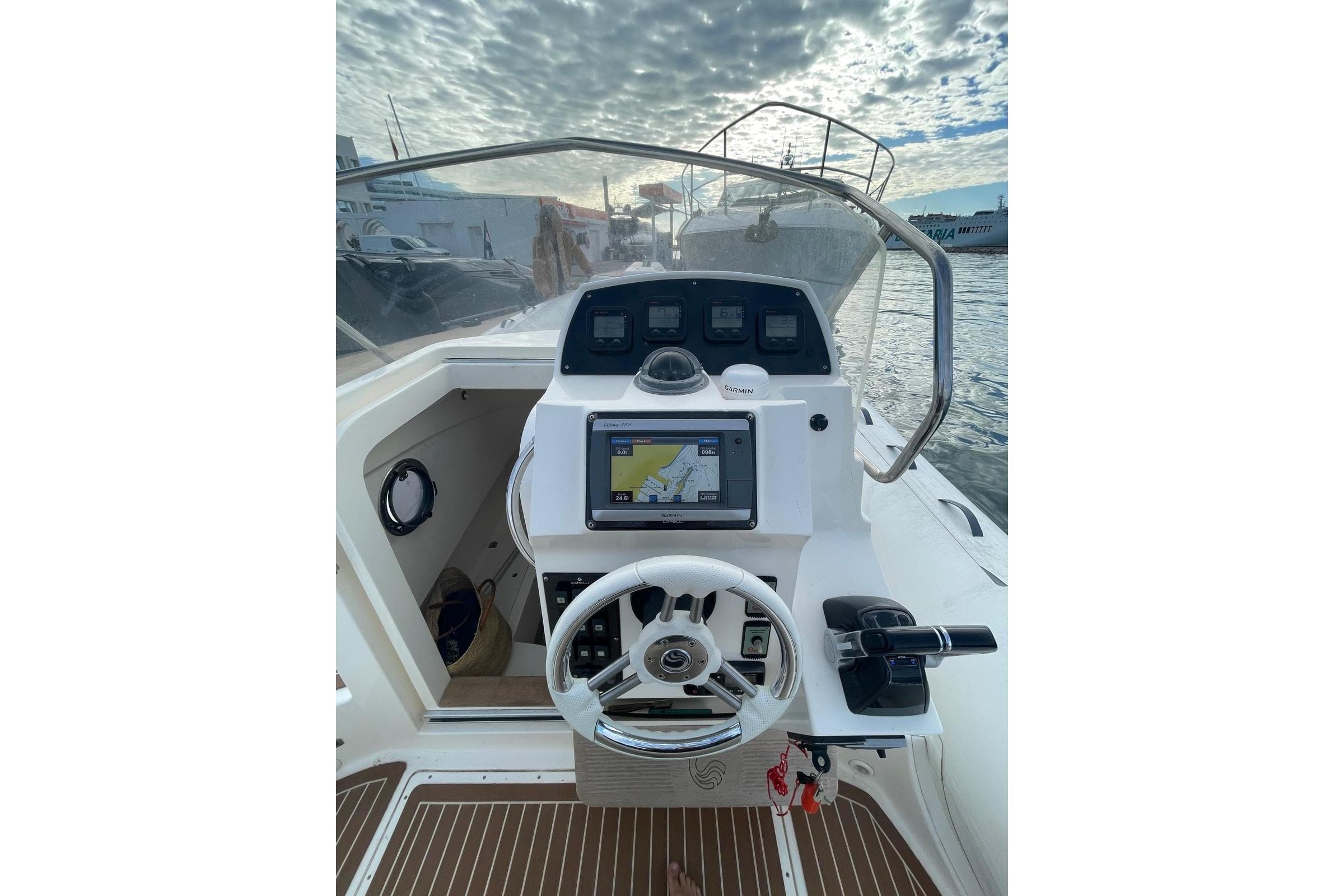 2014 Capelli Tempest 850 boat dashboard with navigation system and steering wheel.
