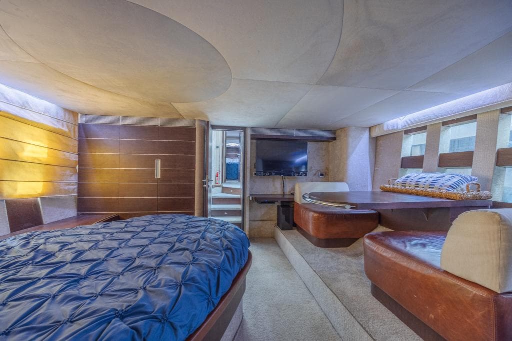 Luxurious interior of 2009 Azimut 68S yacht with modern furnishings and cozy seating area.