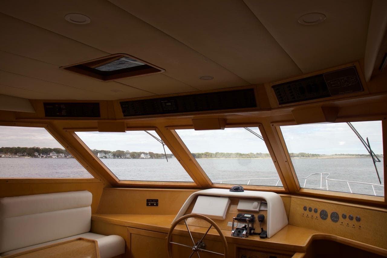 Interior view of 2002 McKinna 57 Pilothouse yacht with panoramic windows.