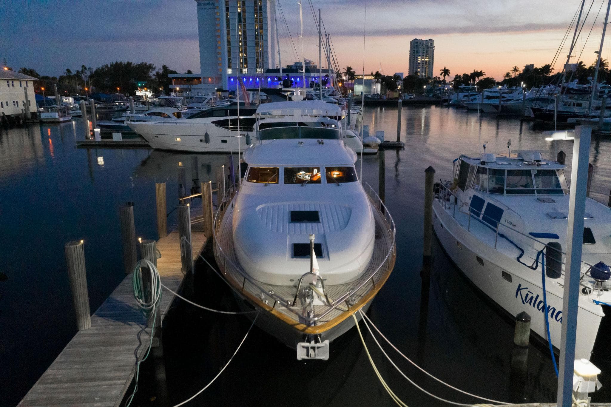 1997 Maiora FIPA 70' Flybridge yacht docked at marina during sunset.