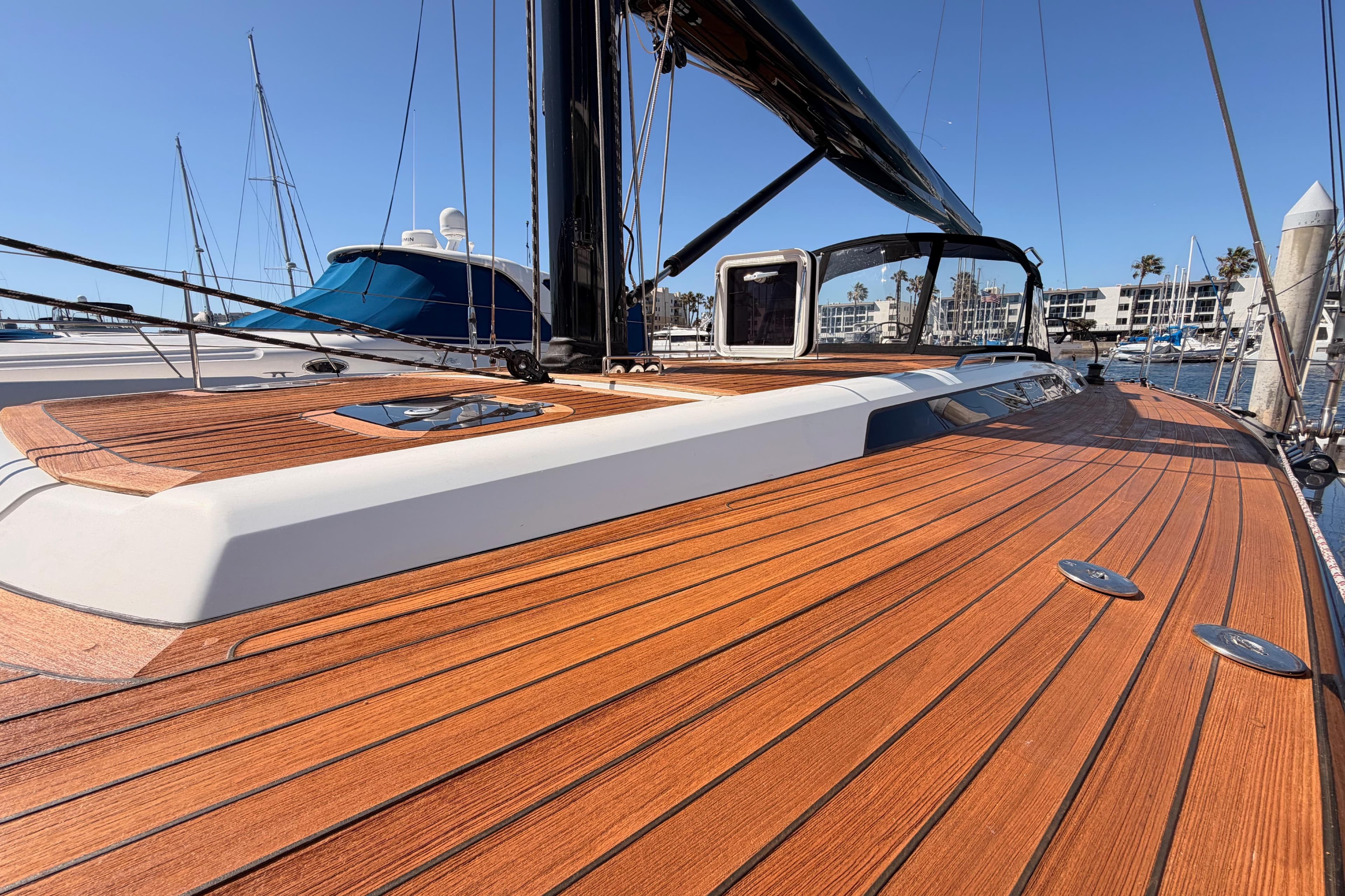 Luxurious 2017 Solaris 50 yacht with sleek wooden deck in marina setting.