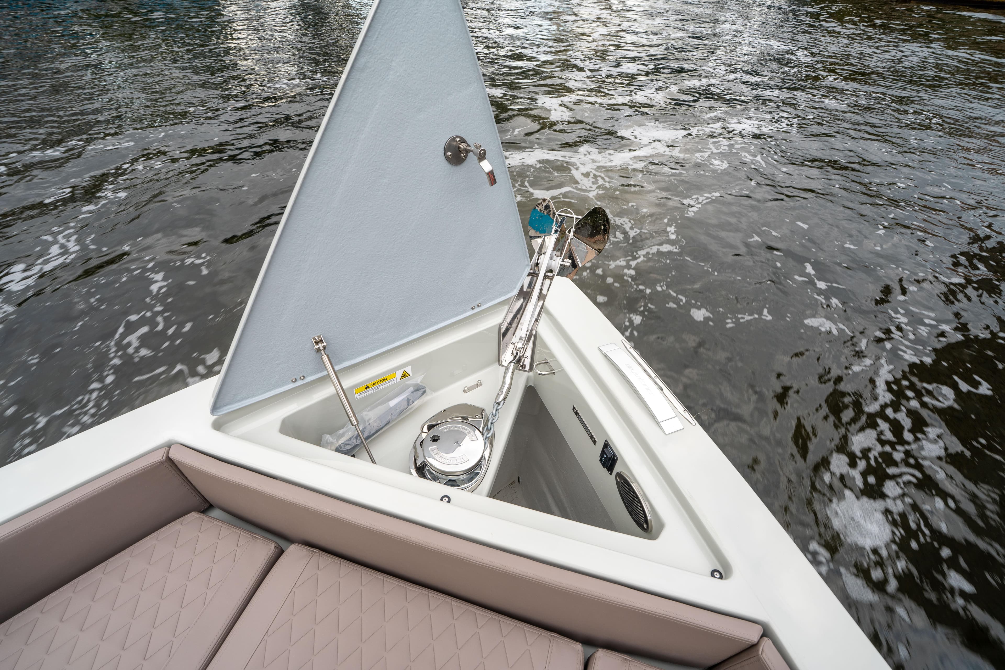 2025 De Antonio Yachts D42 Open anchor compartment with water view.