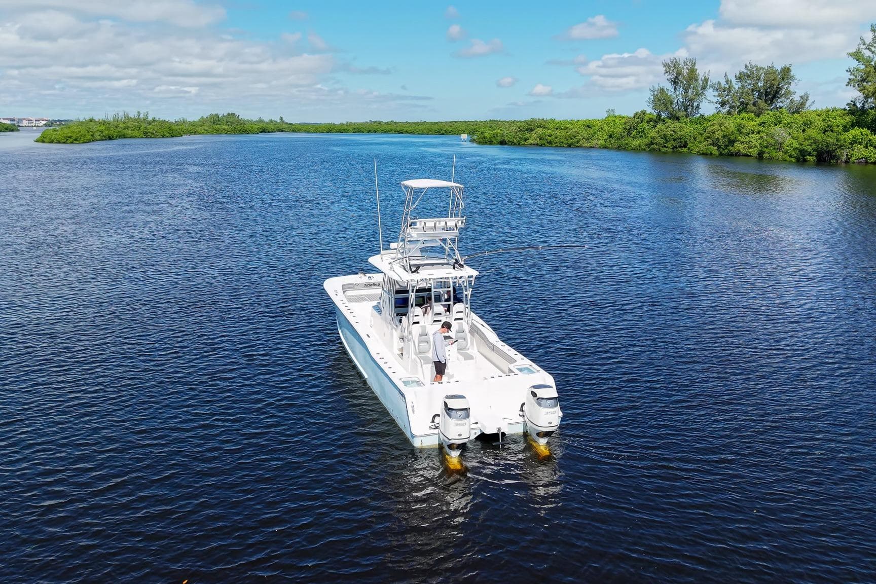 Aerial view of 2020 Tideline 365 Offshore boat cruising on a serene waterway.