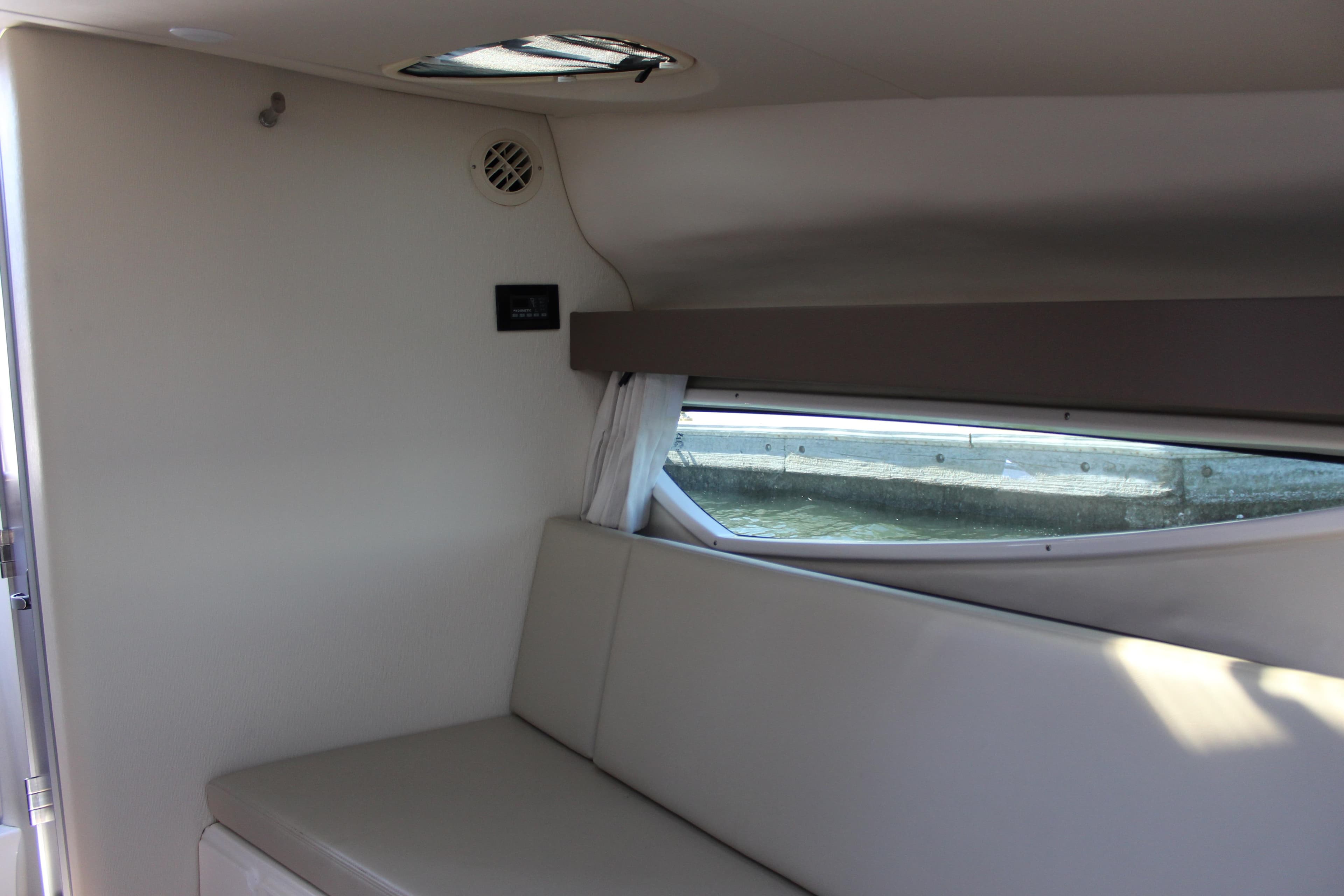 Interior of 2018 Regal 28 Express boat with seating and window view.
