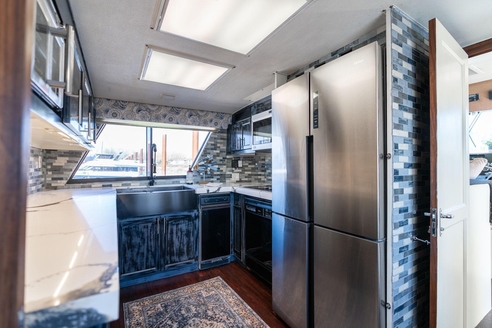 Modern kitchen interior of 1986 Hatteras 63 Motor Yacht with stainless steel appliances.