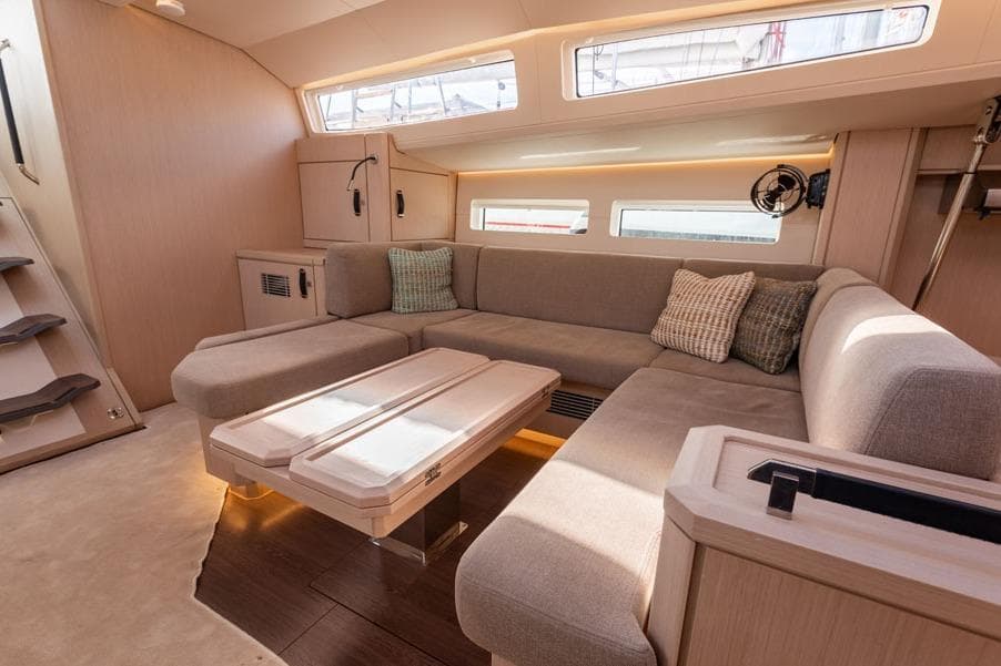 Luxurious interior of 2023 Jeanneau 60 yacht with modern seating and elegant design.