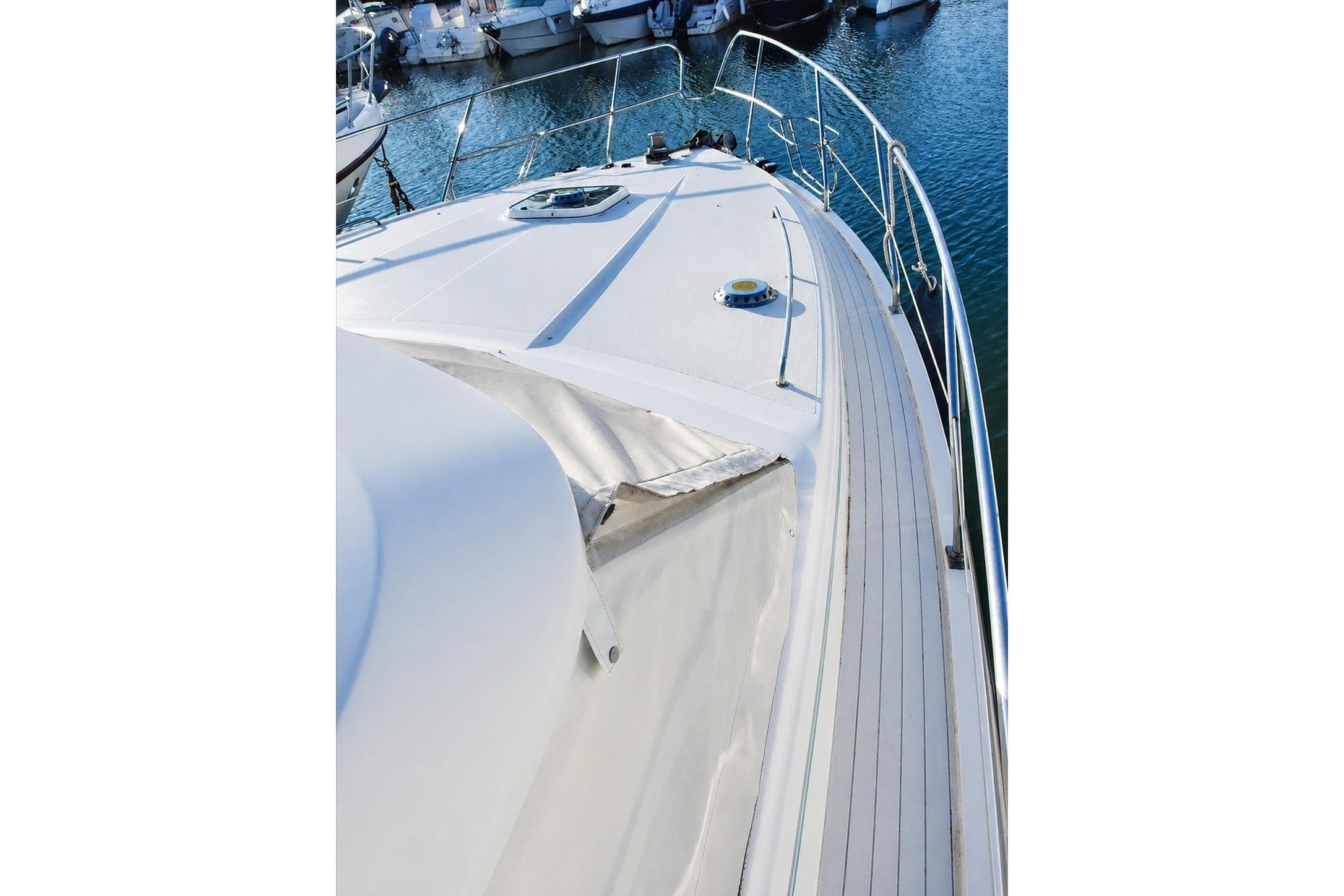 Deck view of a 1993 Princess 410 yacht docked in a marina.
