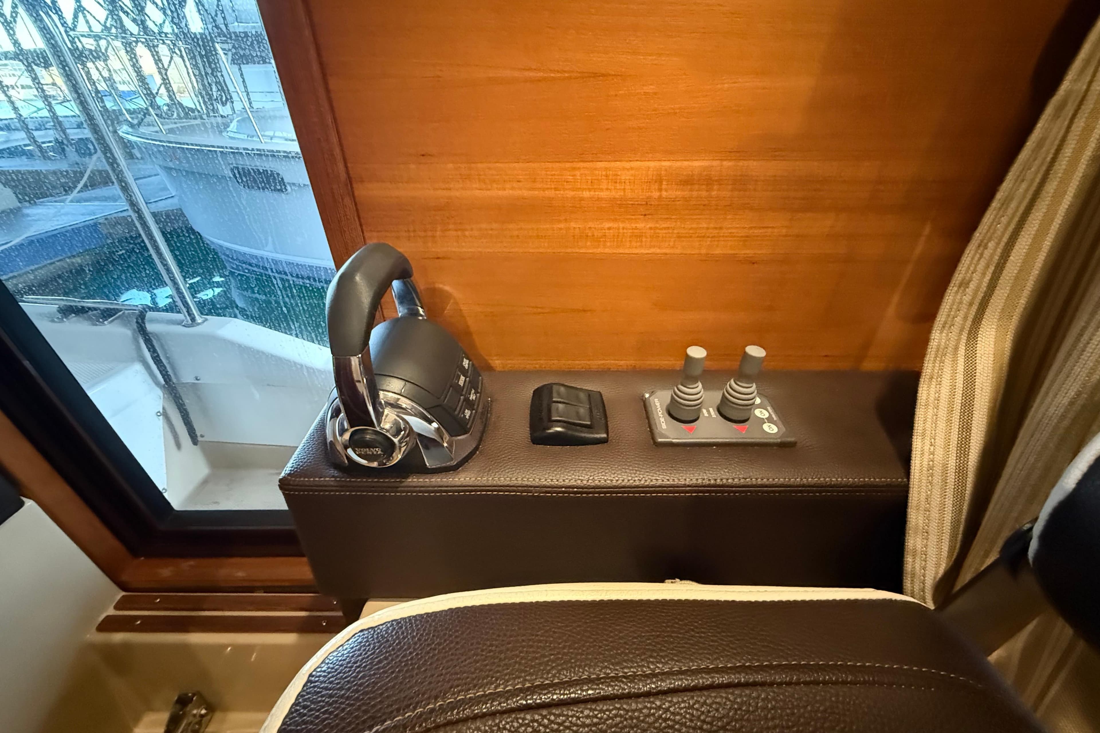 Interior helm controls of 2016 Ranger Tugs R-31 CB boat, featuring throttle and joystick.