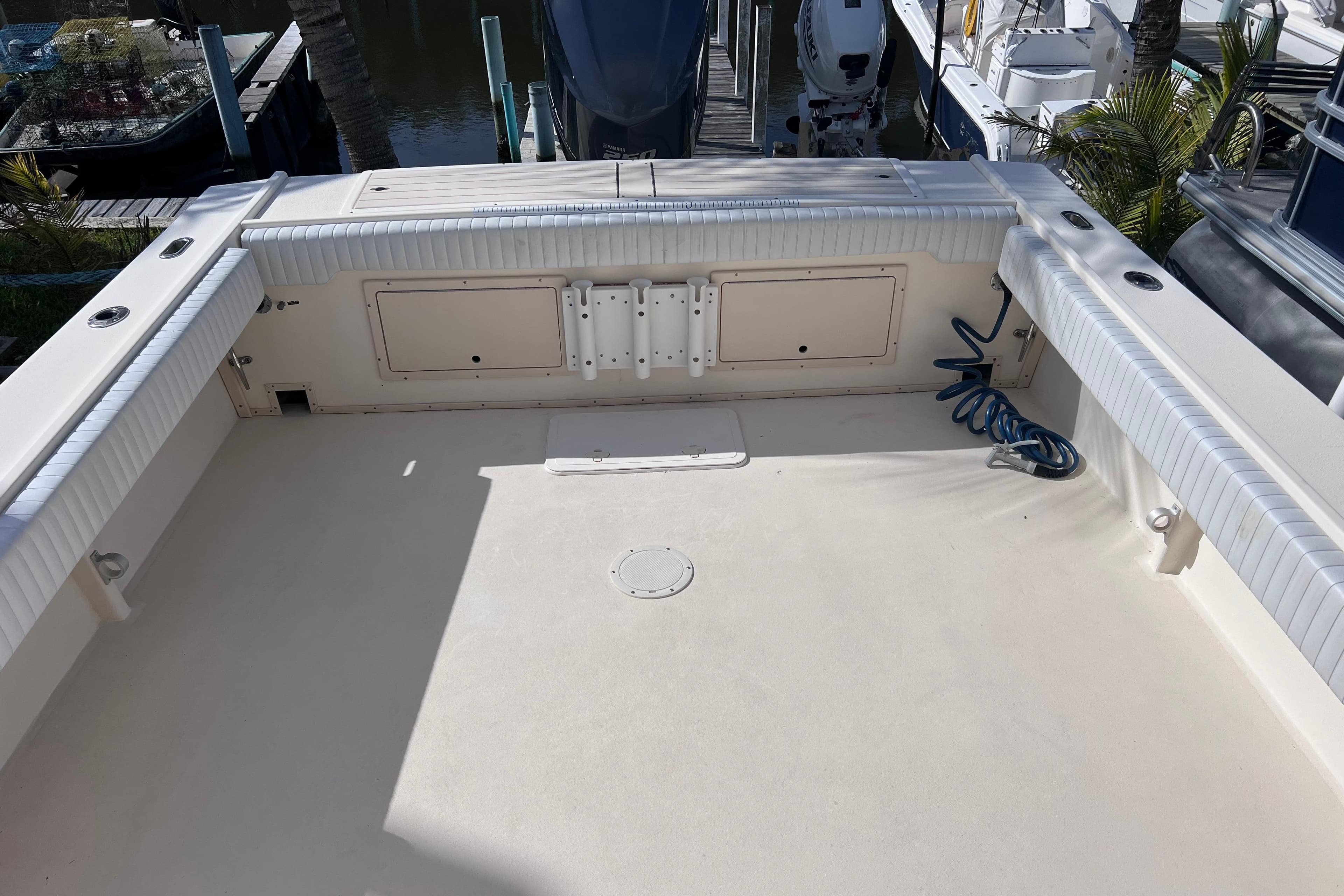 2005 Parker 2510 Walkaround boat deck with storage compartments and coiled hose.