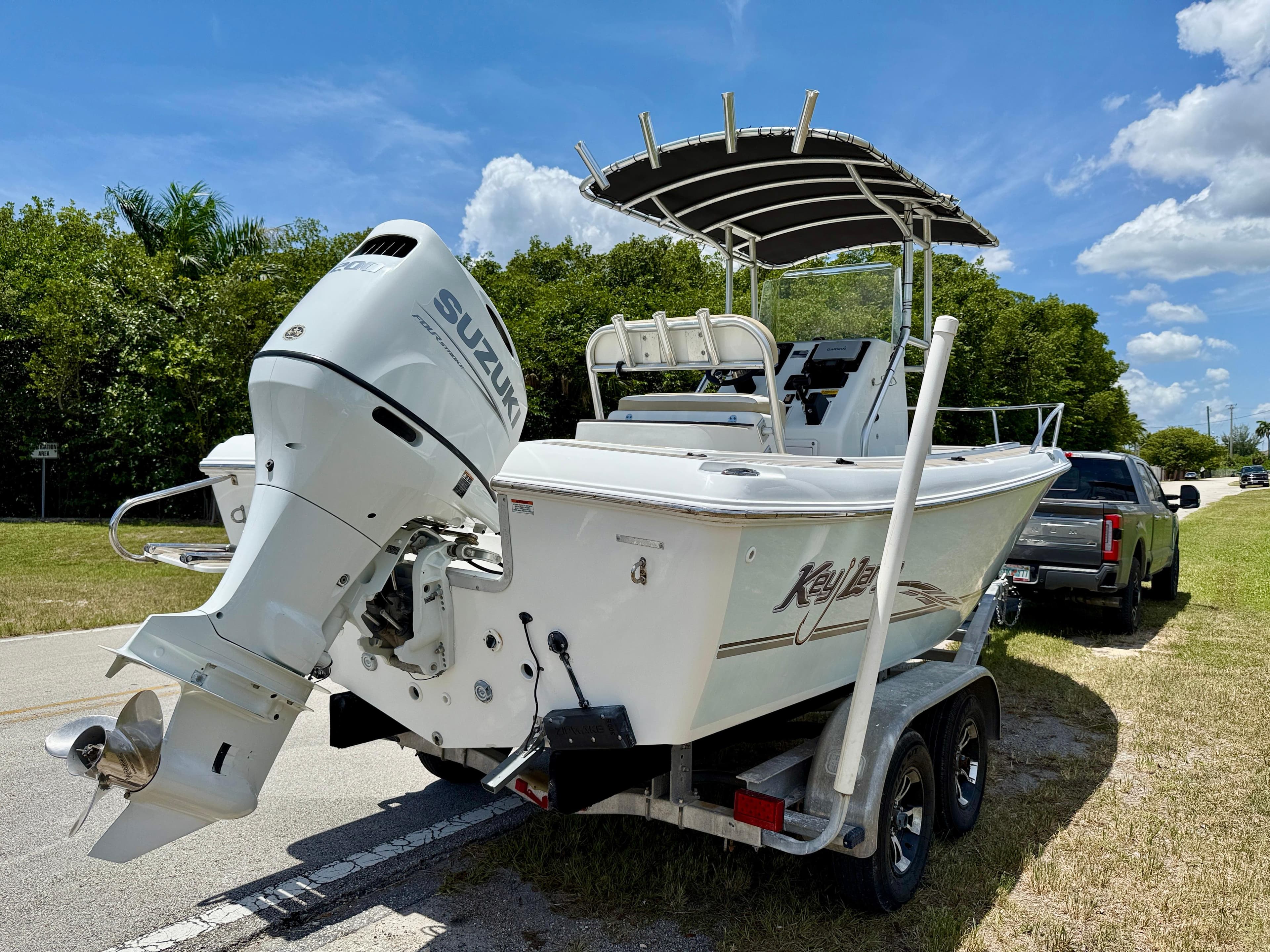 2016 Key Largo 2100 WI CC boat on trailer with Suzuki outboard motor.