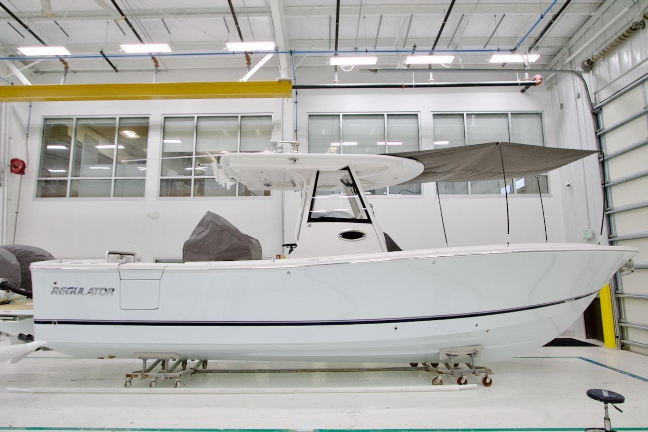 2026 Regulator 31 boat in a well-lit indoor facility, side view.